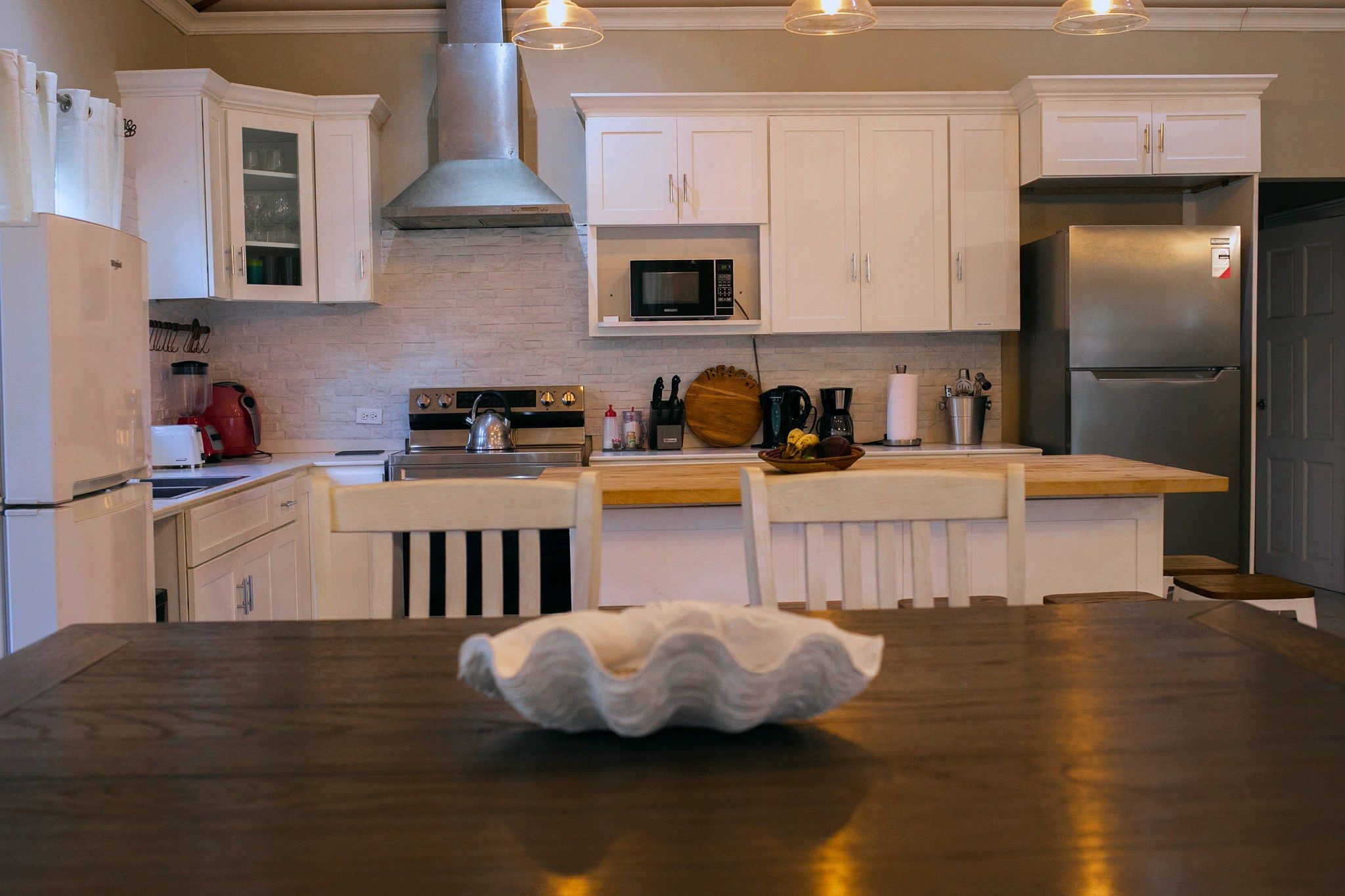 Kitchen with white cabinets and dining table