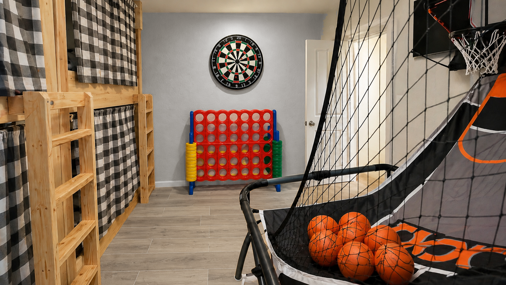 Family-friendly game room with hoops, giant Connect Four, and cozy bunks