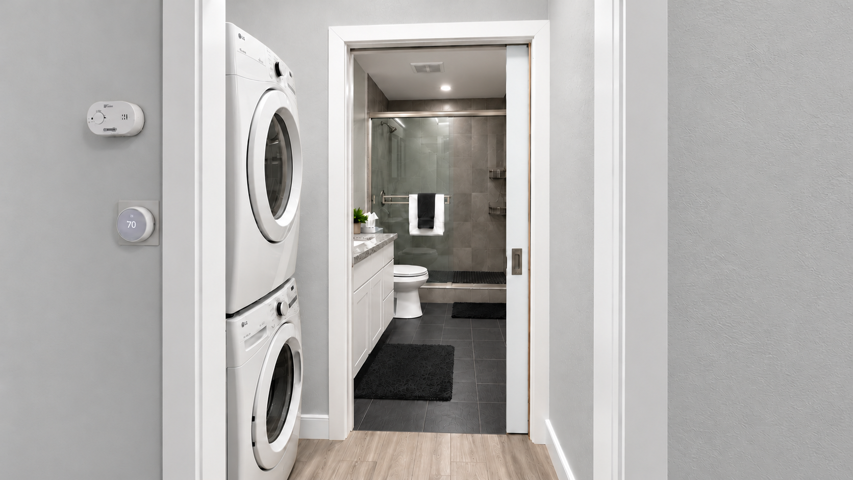 Modern bath with walk-in shower plus in-unit washer and dryer