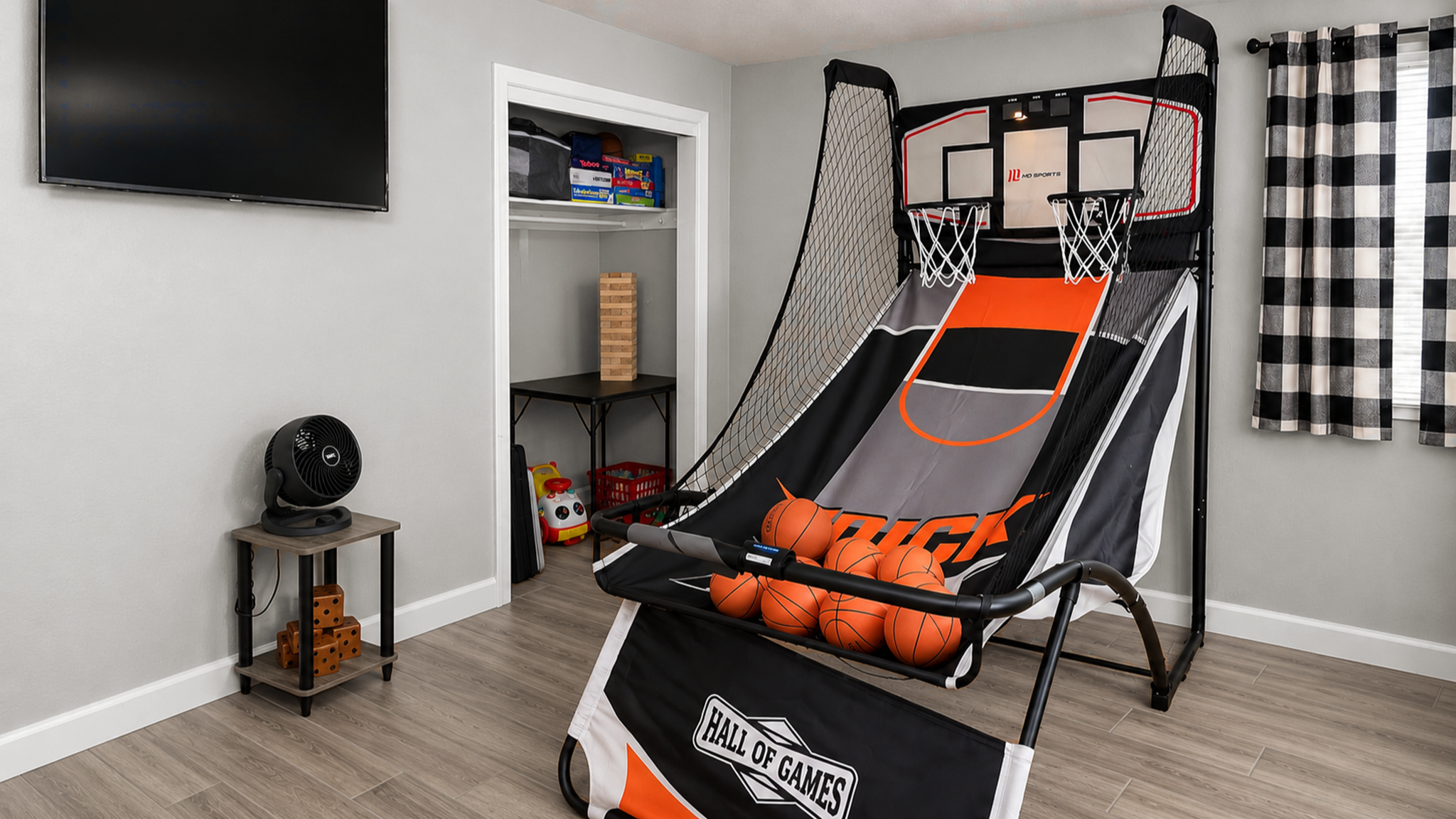 Fun game room with dual basketball arcade and TV entertainment
