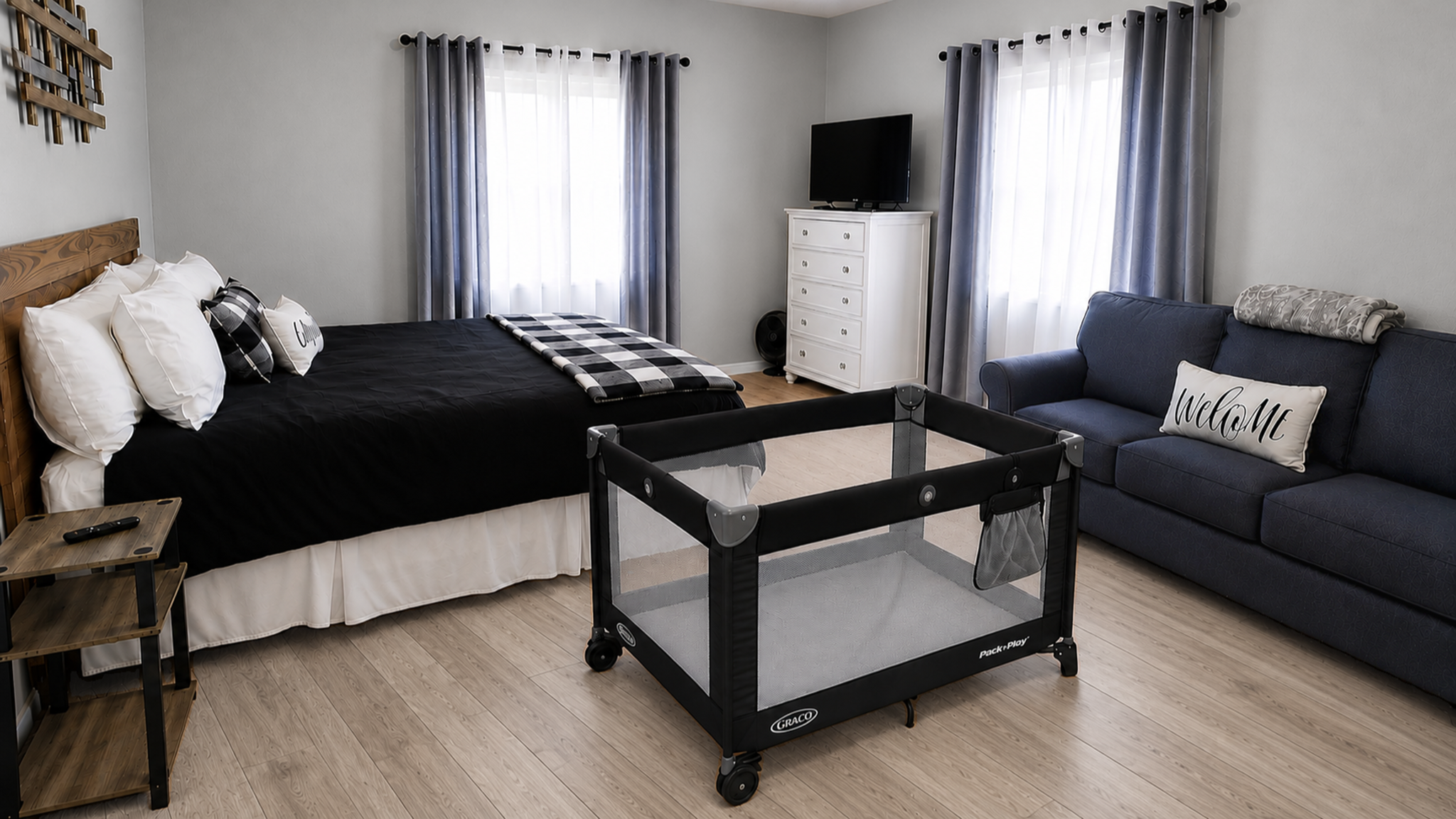 Bright, family-friendly bedroom with loveseat, TV, and playpen