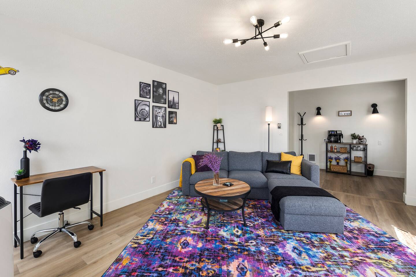 Bright and inviting, this living room combines modern flair with historic charm. Relax on the plush sectional, enjoy natural light from large windows, or unwind with a movie on the smart TV. Perfect for lounging or working in style.
