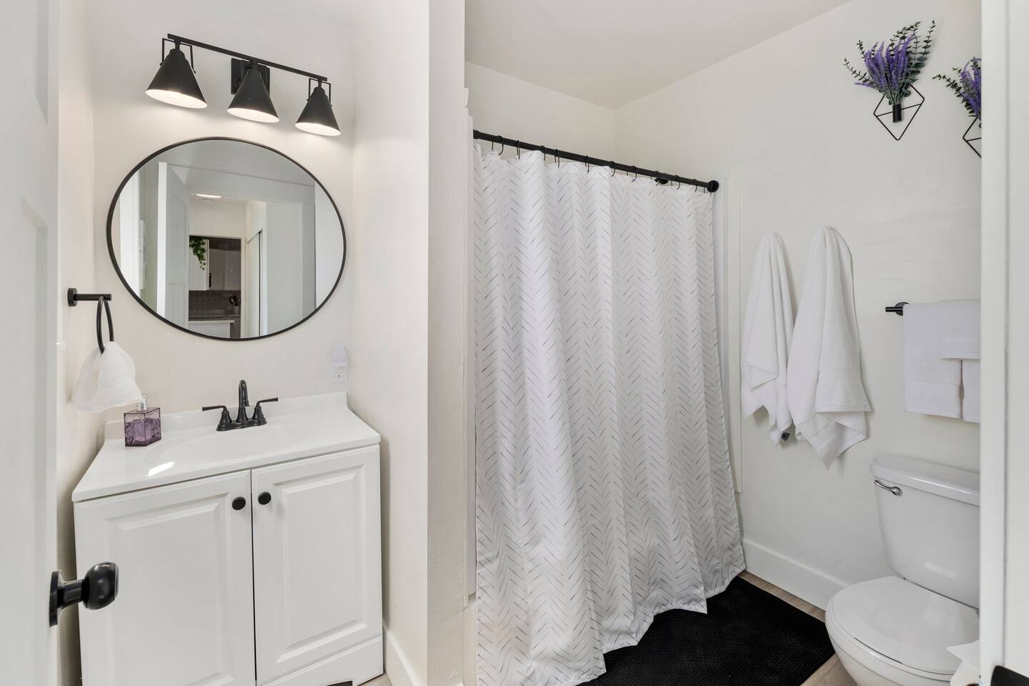 Modern bathroom with clean lines, bright lighting, and all the essentials. Refresh yourself in this sleek, functional space that perfectly complements the home’s blend of old-world charm and contemporary comfort.