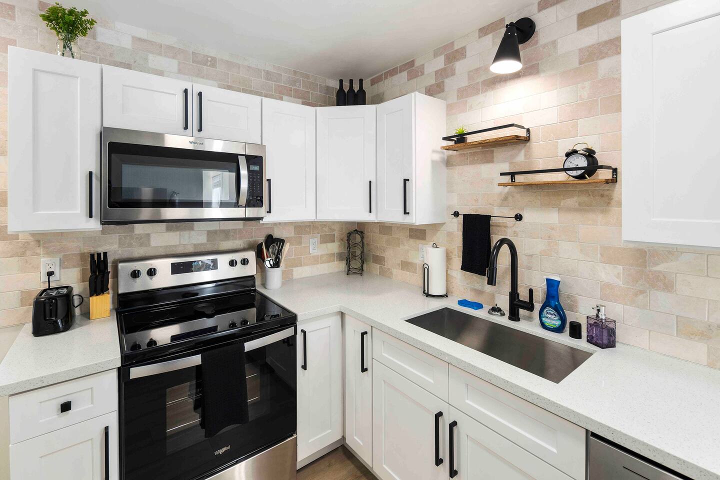 Sleek, modern kitchen with new appliances and a charming coffee station. Perfect for preparing meals or enjoying your morning brew. The kitchen’s design blends contemporary convenience with a touch of classic elegance.