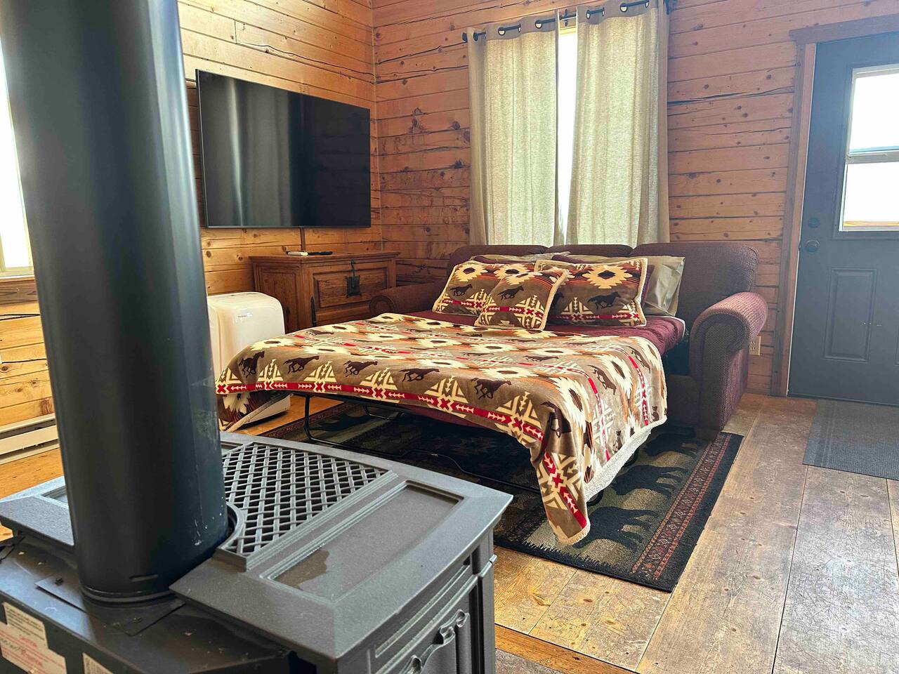 Very comfortable Queen sized pull-out couch with new bedding. With the propane stove to warm you on cold nights!