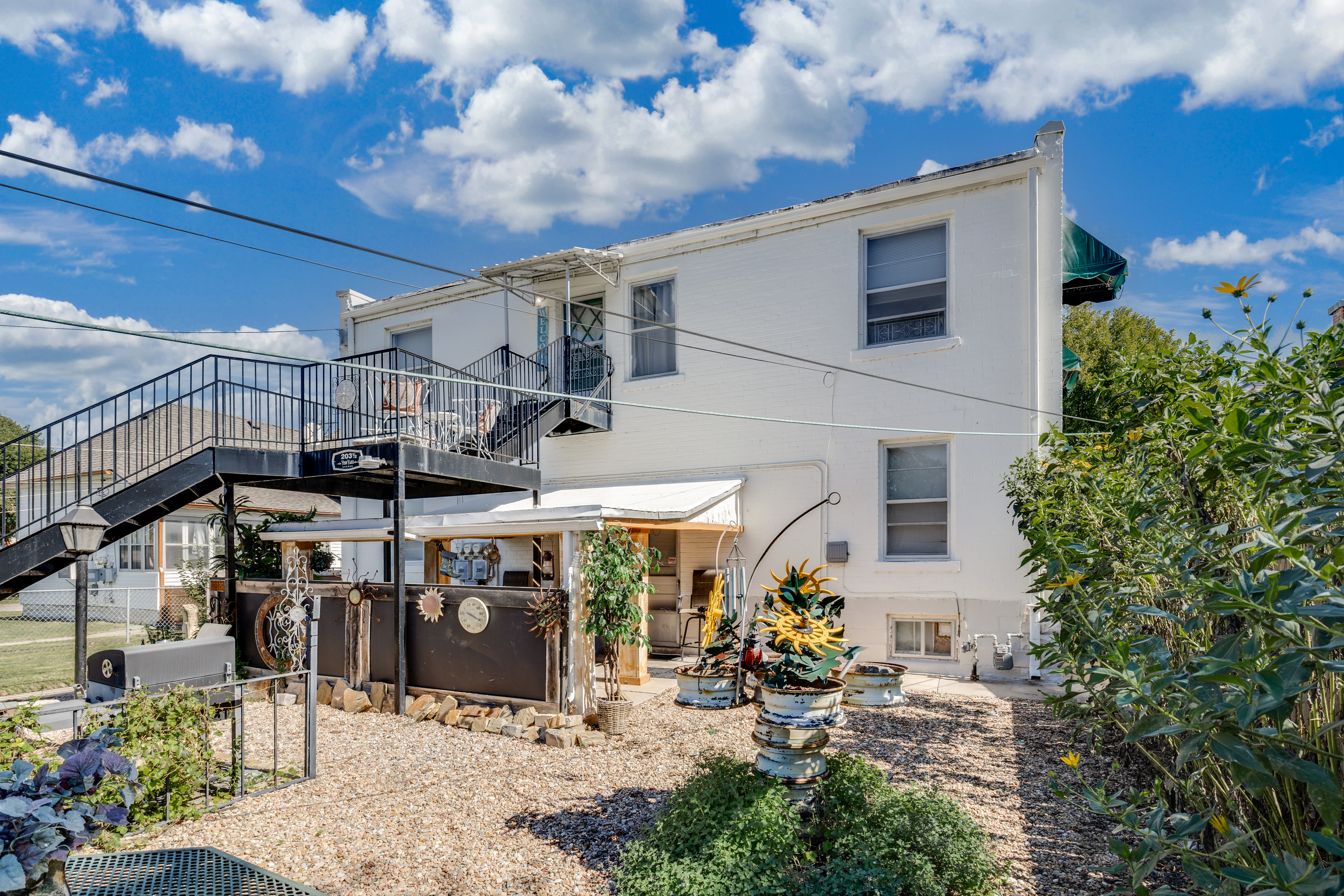 Spacious outdoor courtyard with elevated deck and charming patio details