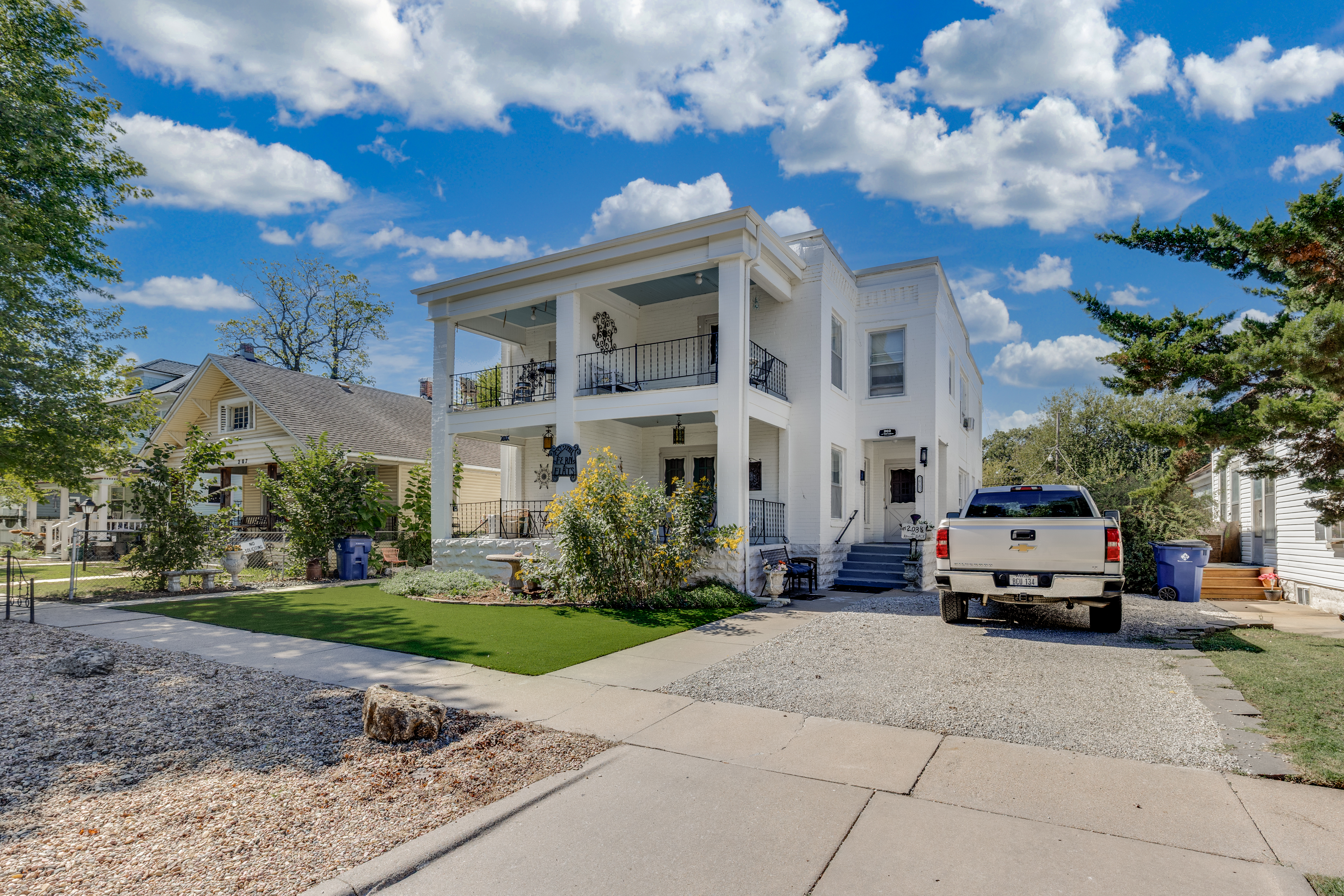 Elegant white home with double porches, curb appeal, and easy parking