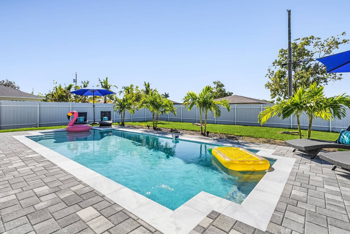 Private heated saltwater pool with sun loungers at Palms Hideaway