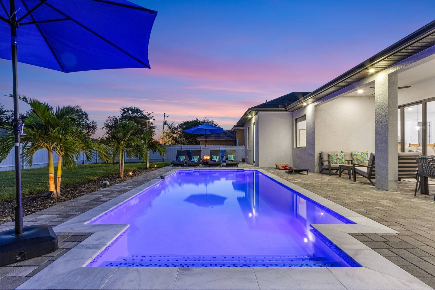 Palms Hideaway heated saltwater pool glowing at night