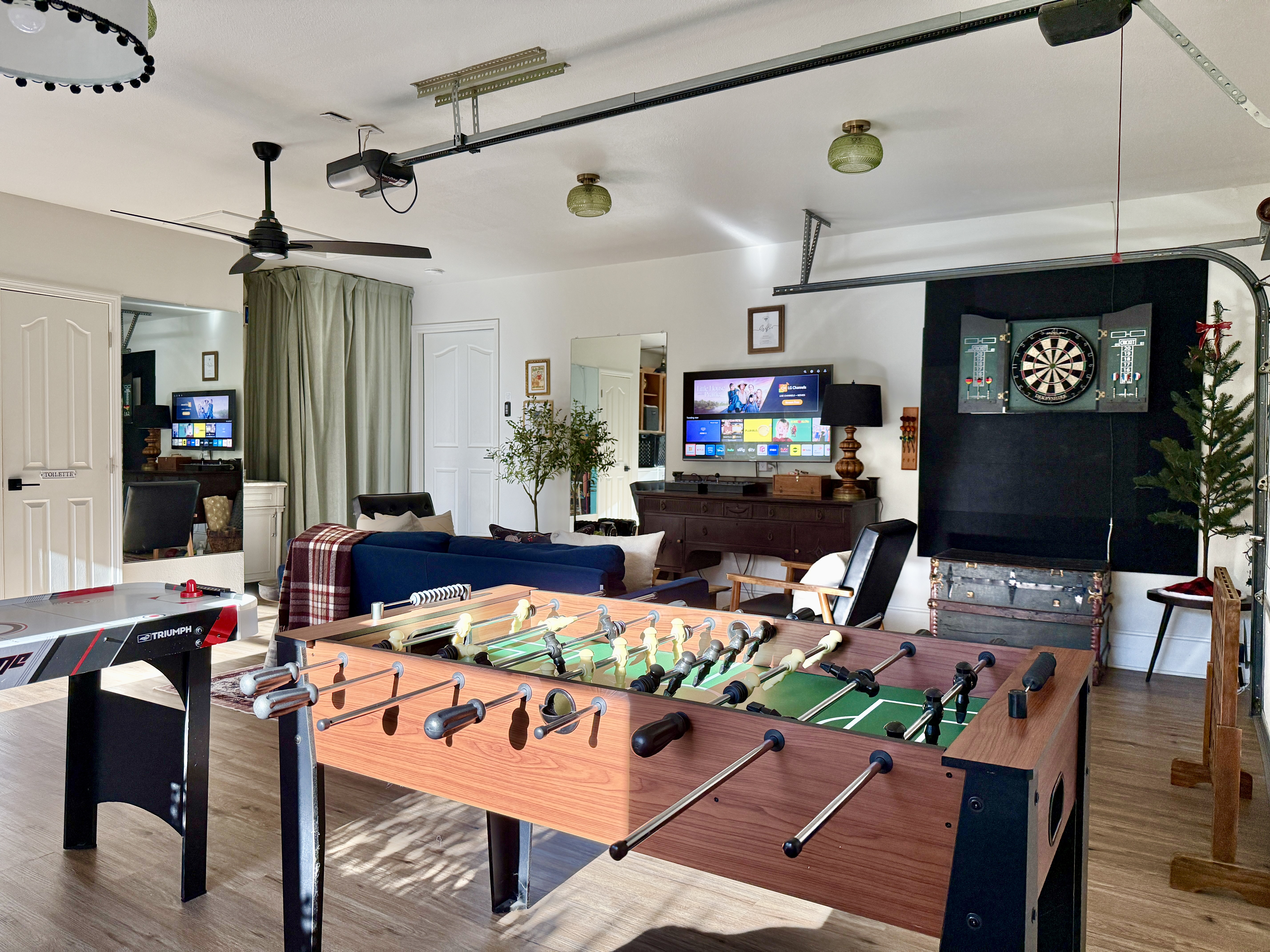 A fully equipped game room with arcade games, foosball, air hockey, darts, 50" TV with yoga mats, poker set & workout gear. There is a water closet & vanity for a 1/2 bath.  We have a space heater in the cool months and a window A/C in summer.