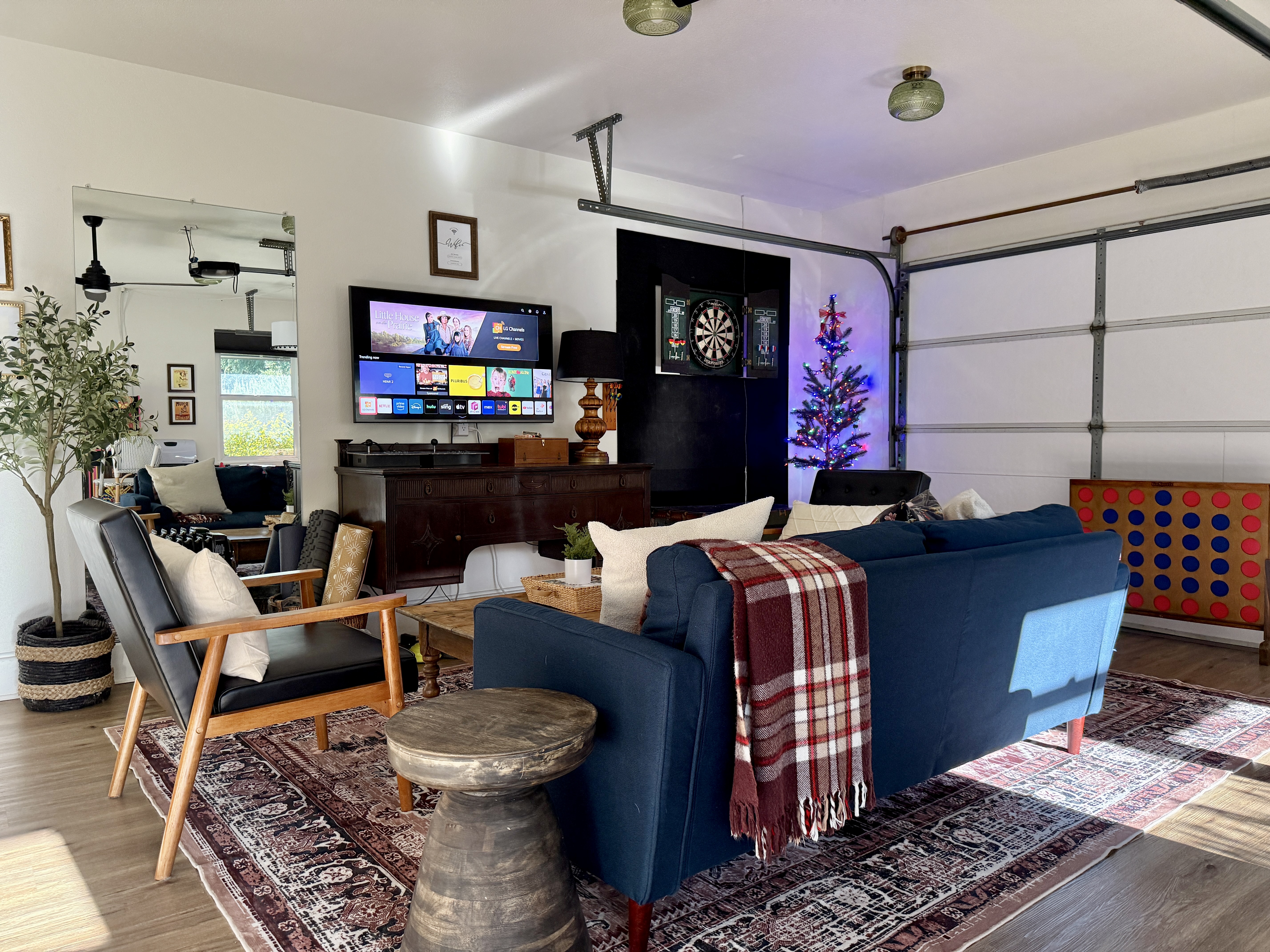 Cozy game lounge with TV, darts, and oversized Connect Four