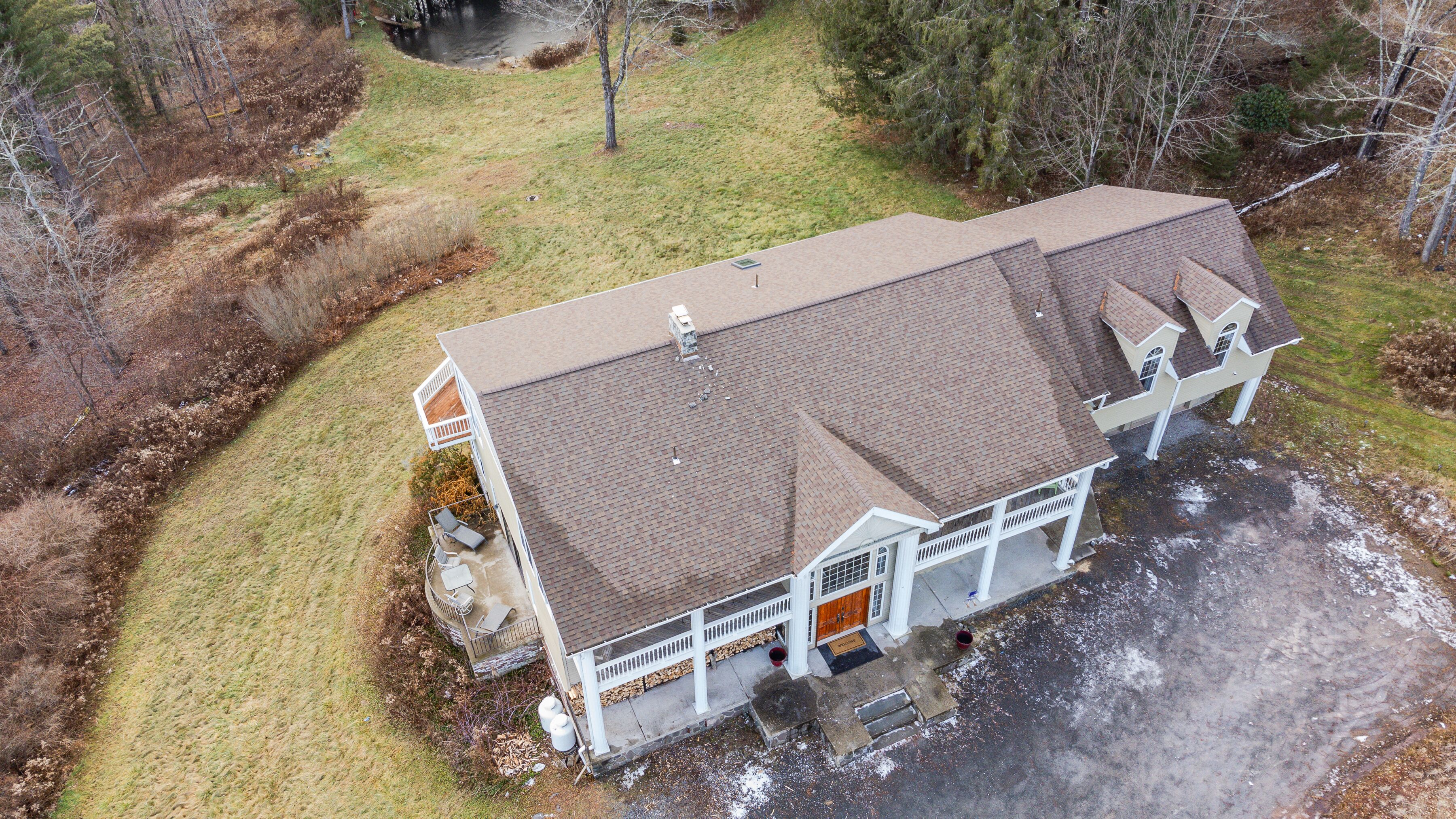 Spacious country home with covered porch, deck, and scenic pond views