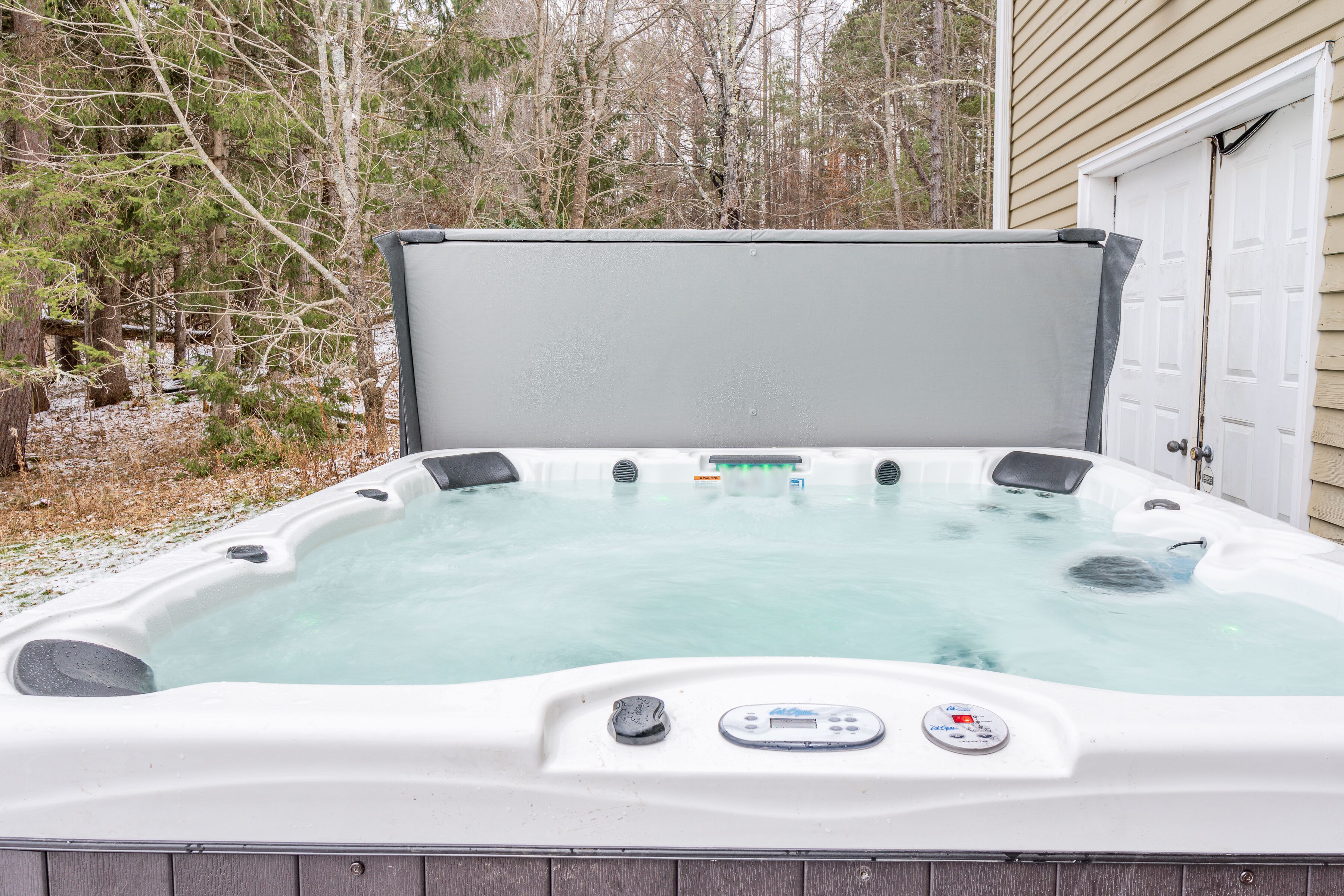 Private outdoor hot tub with peaceful wooded views