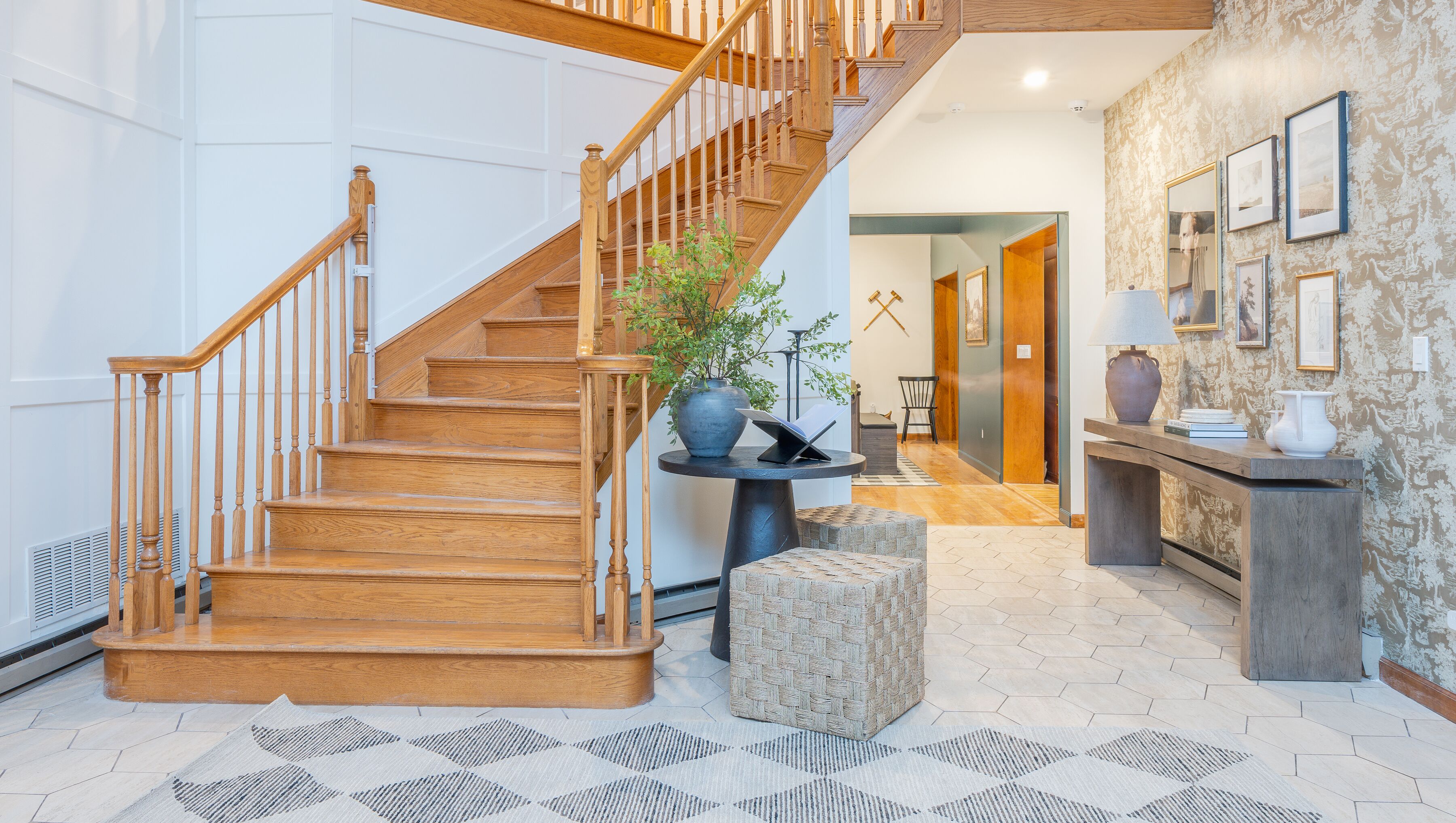 Grand foyer with elegant staircase, high ceilings, and designer finishes