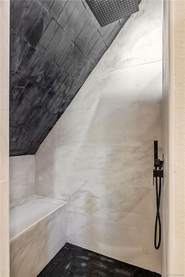 Tiled walk-in shower with a bench