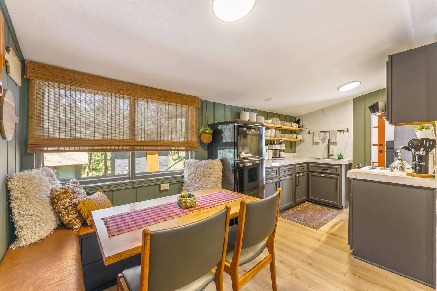 Dining nook with a bench and a window onto the trees