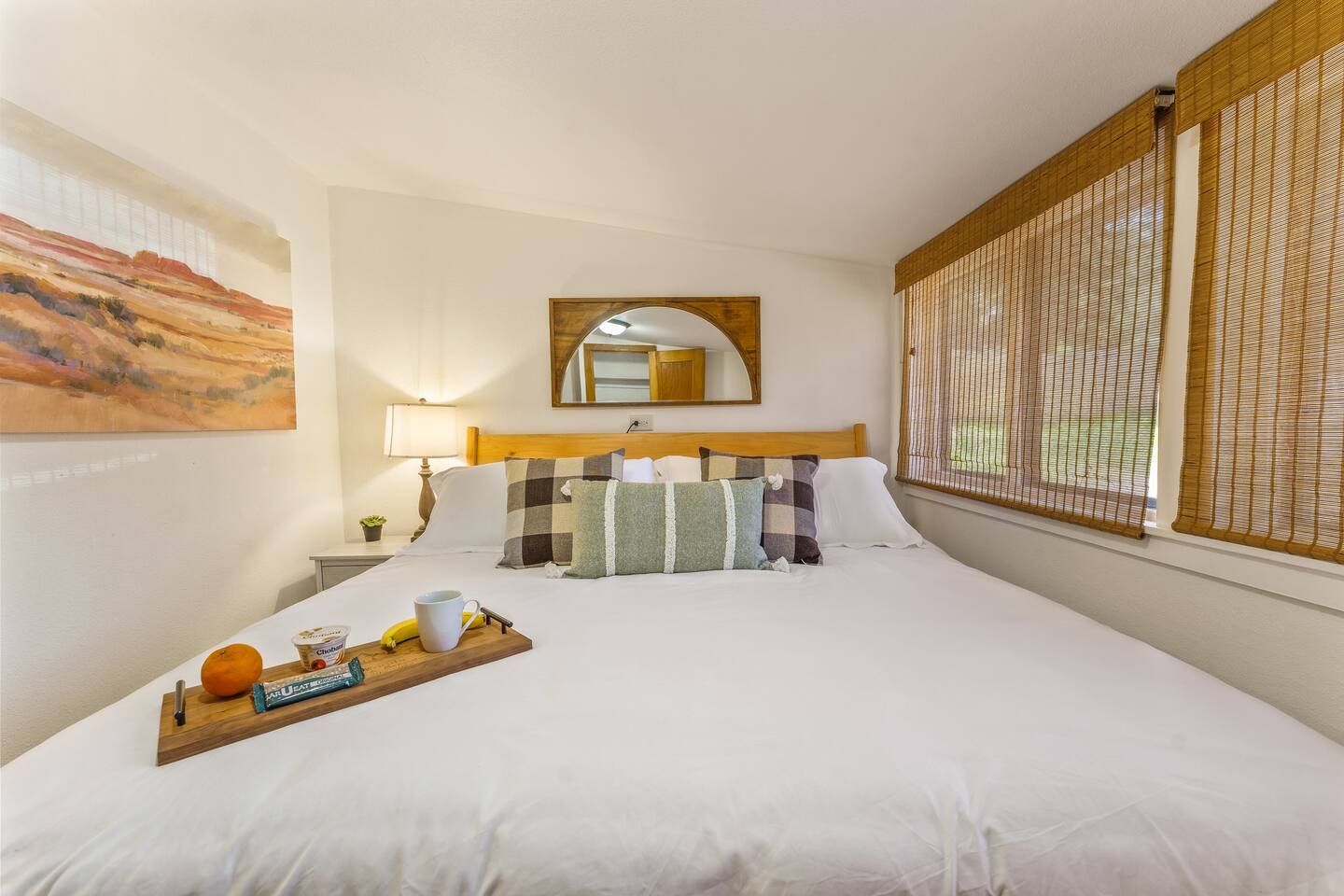 King bedroom with white bedding and a breakfast tray