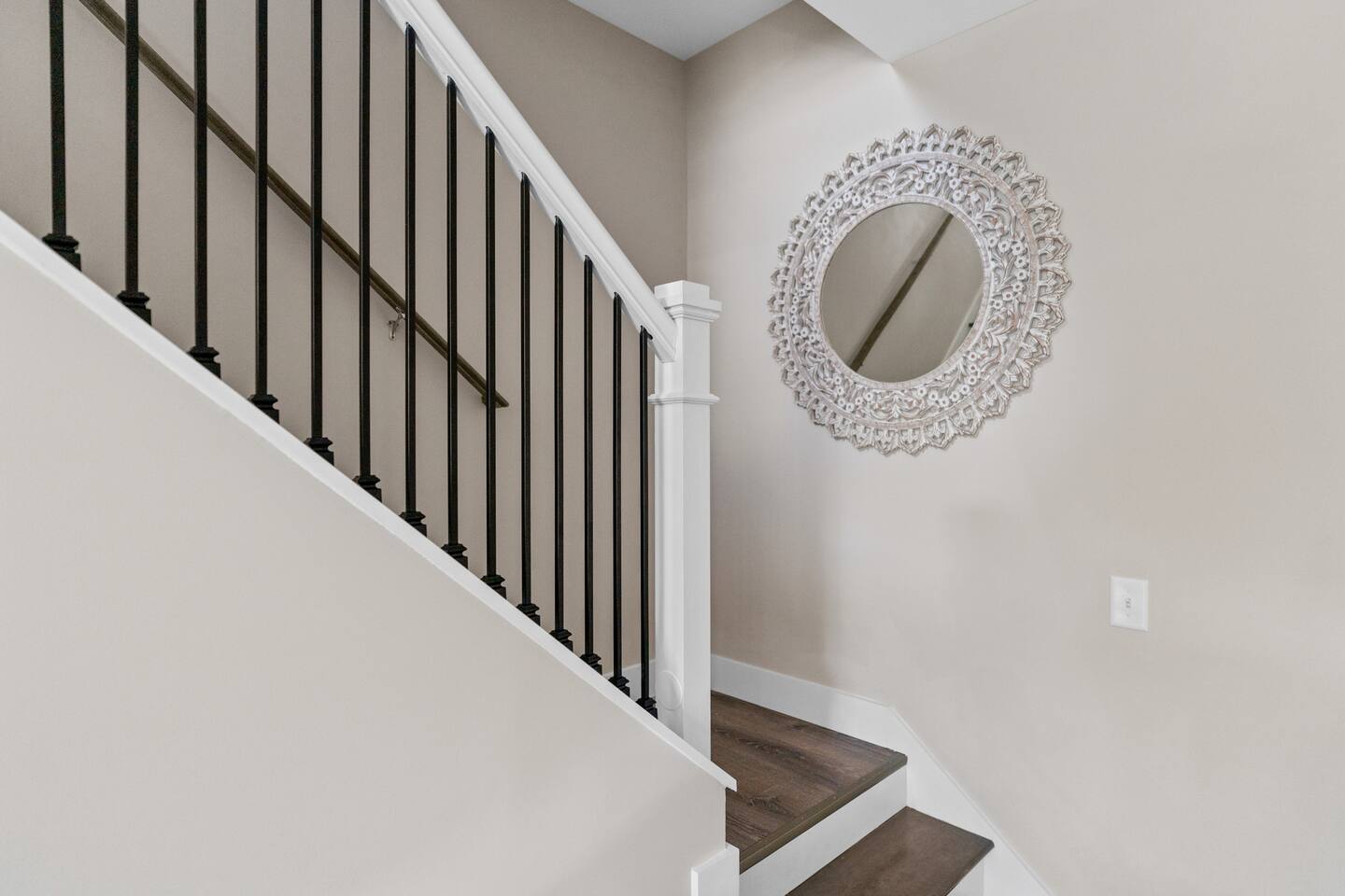 Stairs from dinning room to living room, laundry room, two bedrooms, and another full bathroom.