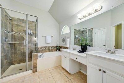 Luxury Primary Full Bathroom!  This spacious ensuite features a large soaking tub and a separate walk-in glass shower with custom tile. Enjoy the double vanity with plenty of counter space and bright overhead lighting. 