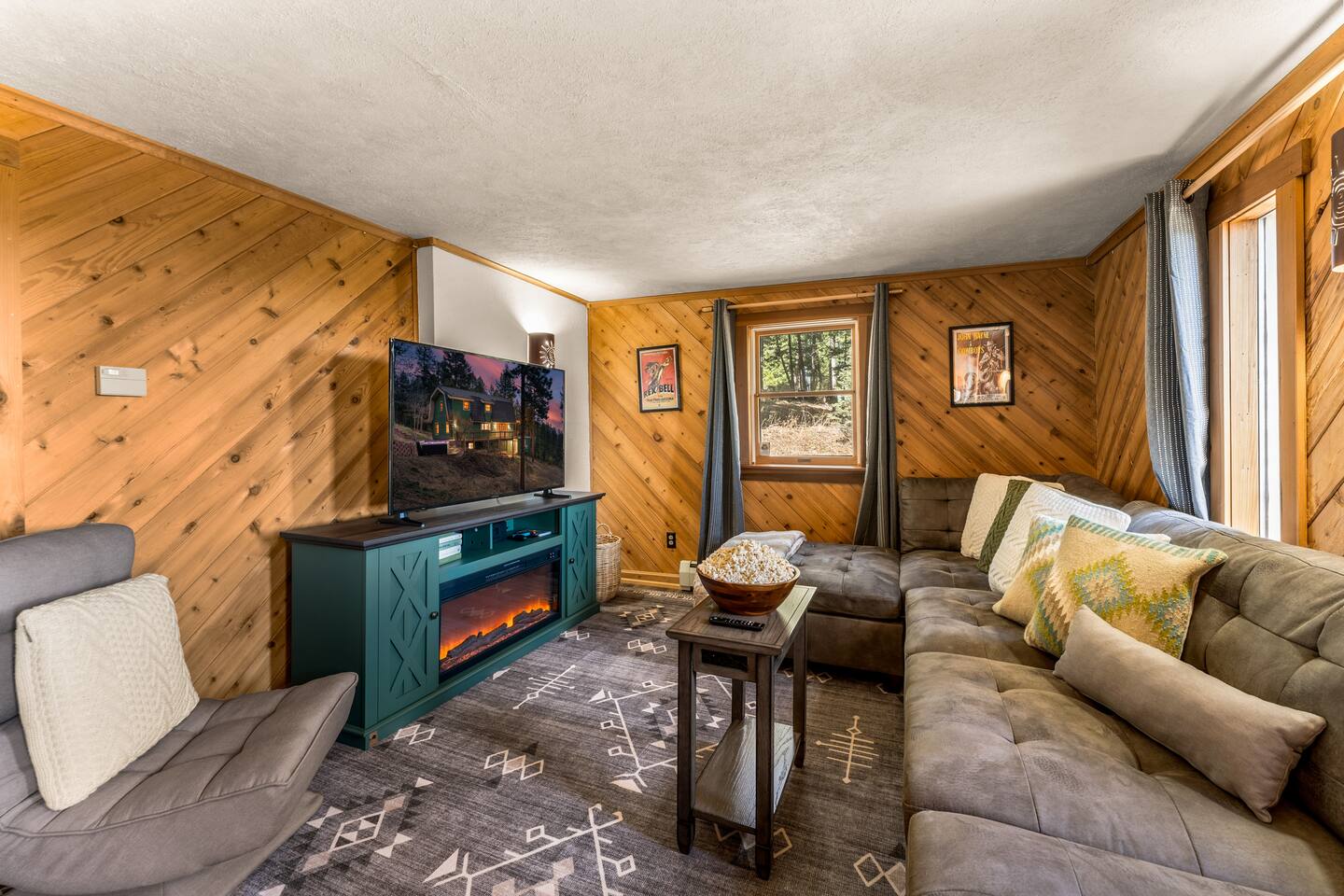TV lounge with a large sectional and an electric fireplace