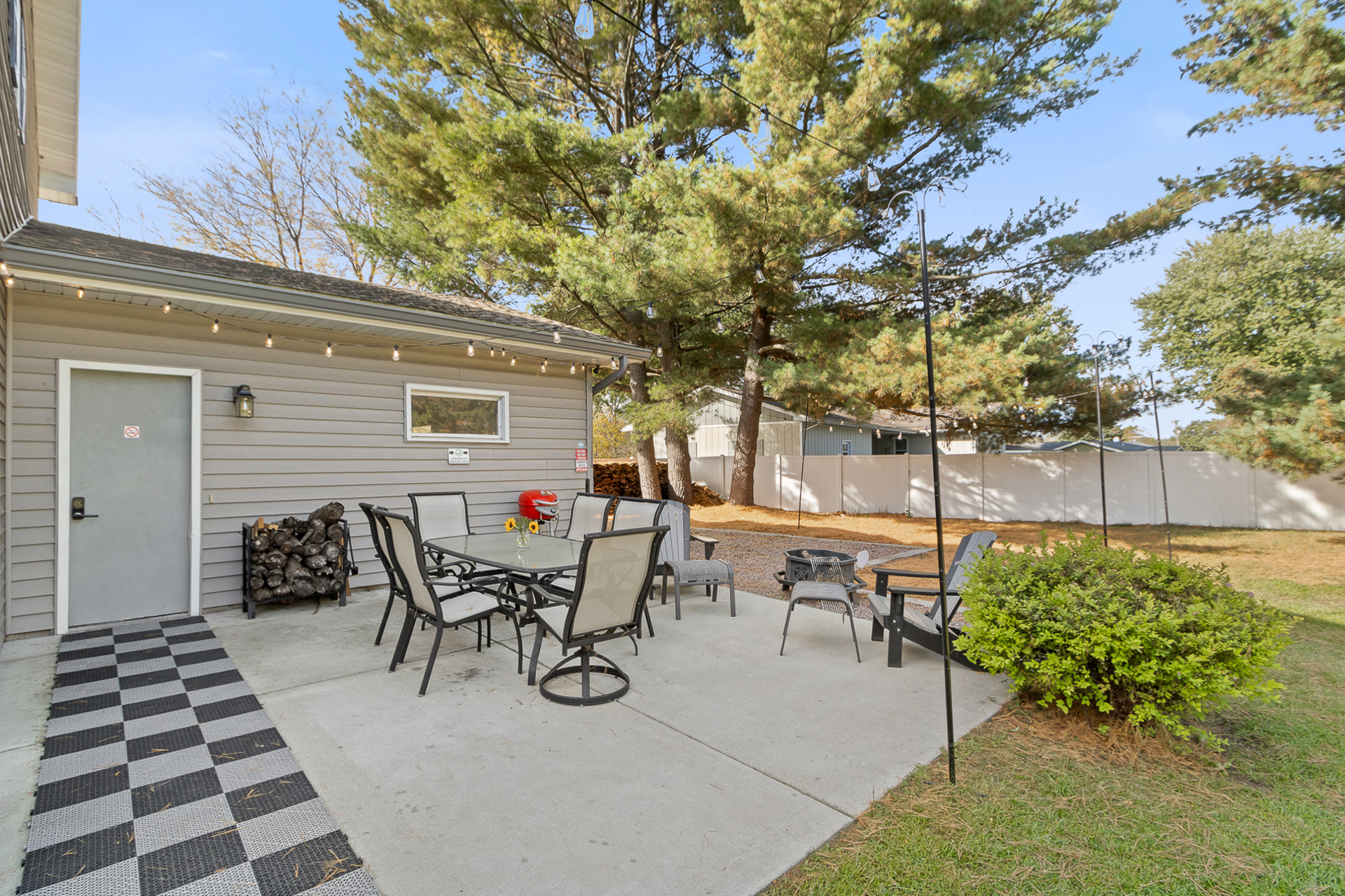 Private backyard patio with outdoor dining and cozy fire pit seating