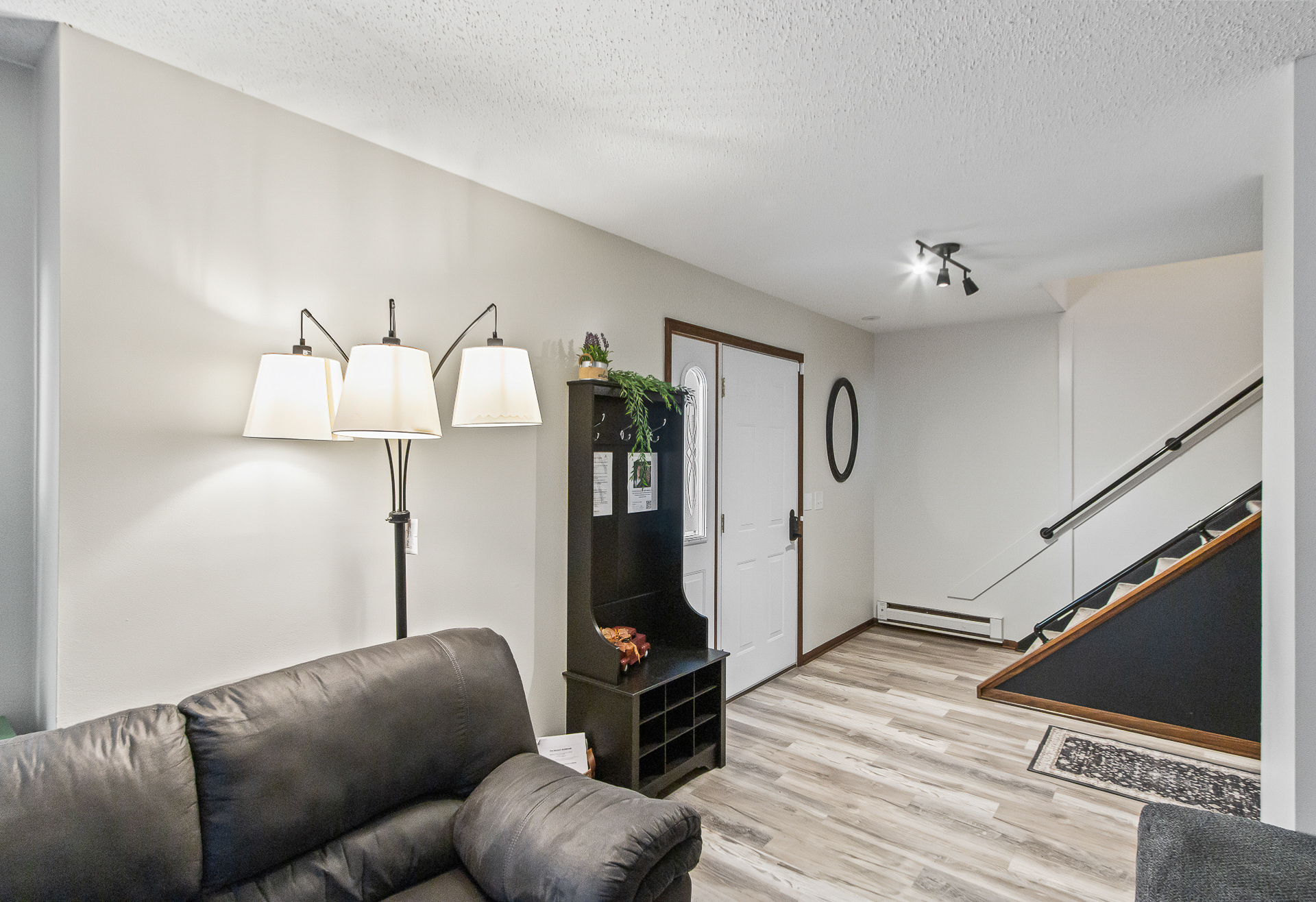 Bright, welcoming entryway with stylish flooring and cozy seating
