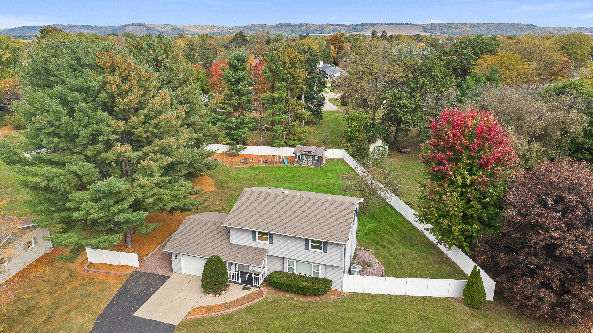 Spacious home with large fenced yard and scenic tree-lined setting