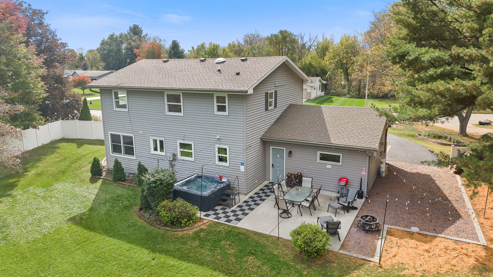 Private backyard retreat with hot tub, patio dining, and fire pit
