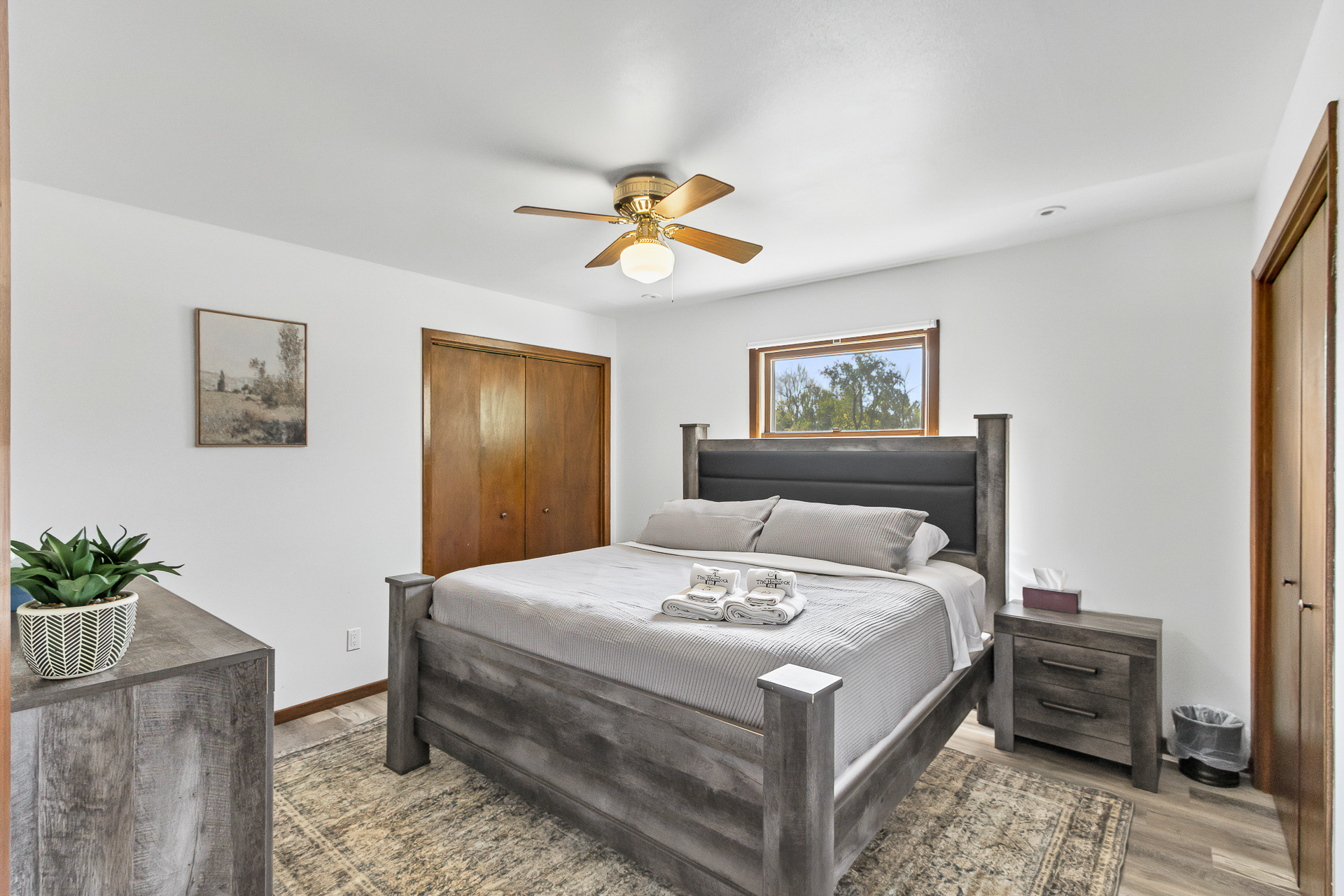 Bright, cozy bedroom with king bed, natural light, and modern rustic style