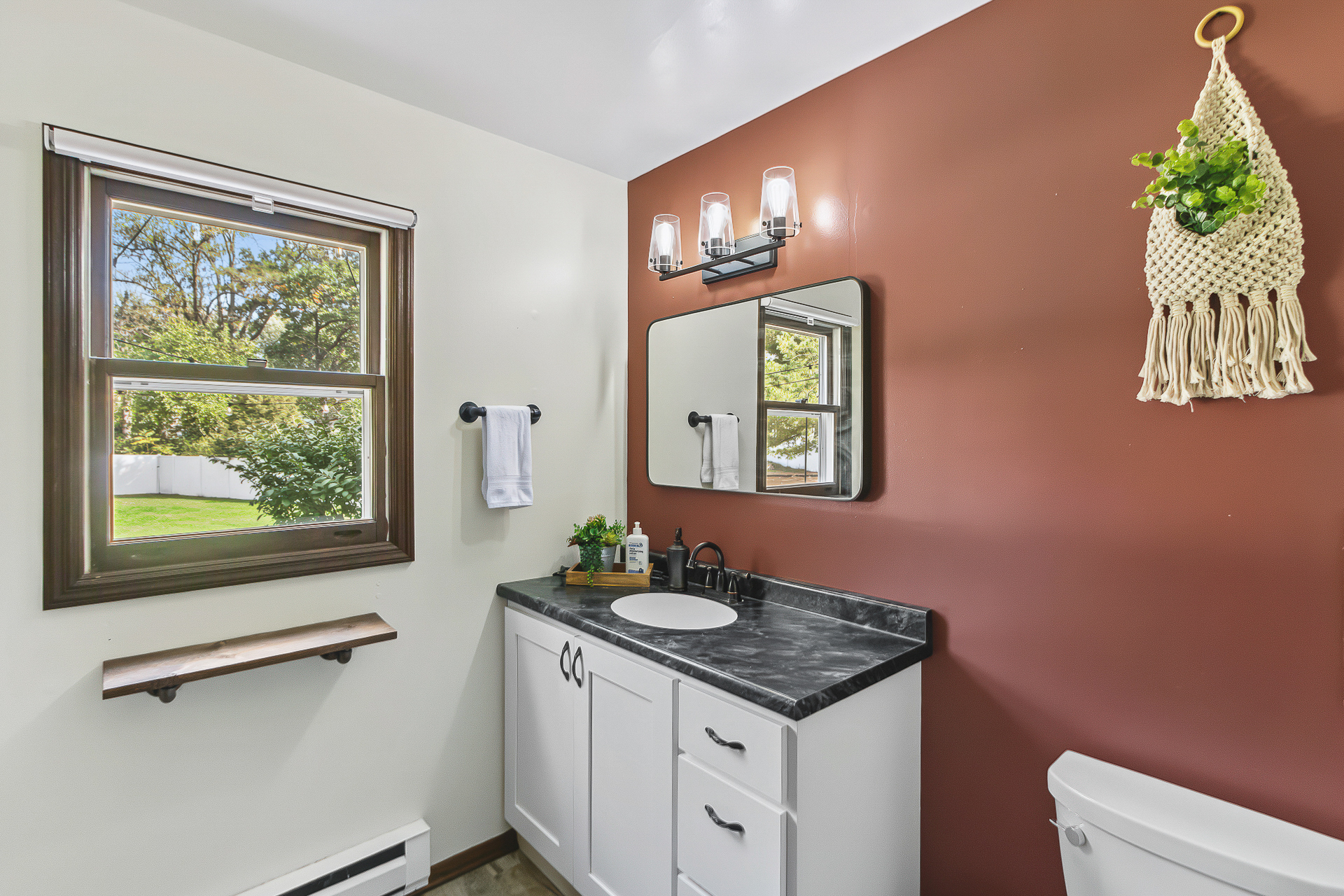 Bright, updated bathroom with natural light and stylish modern accents