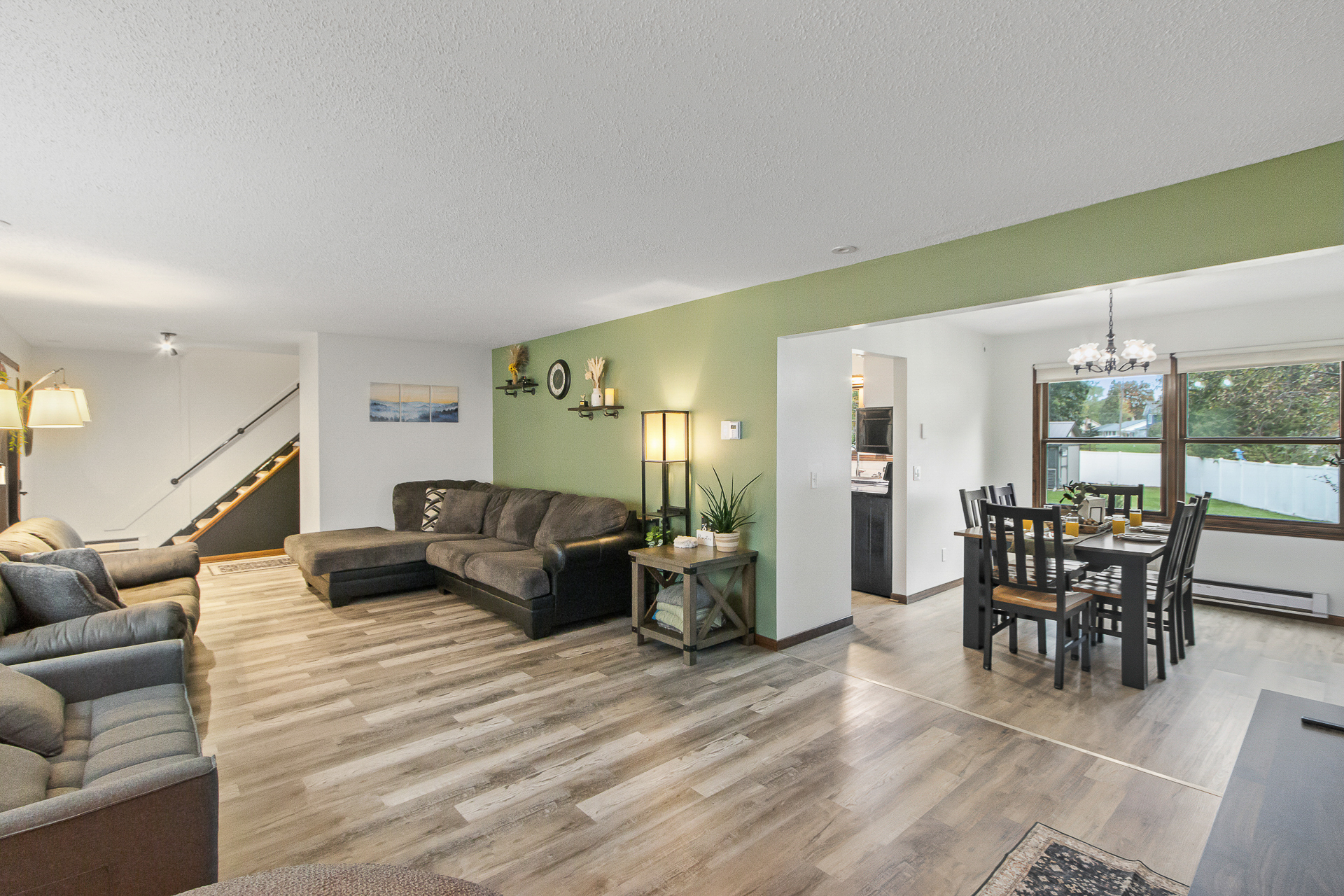 Bright open living and dining area with roomy seating and natural light