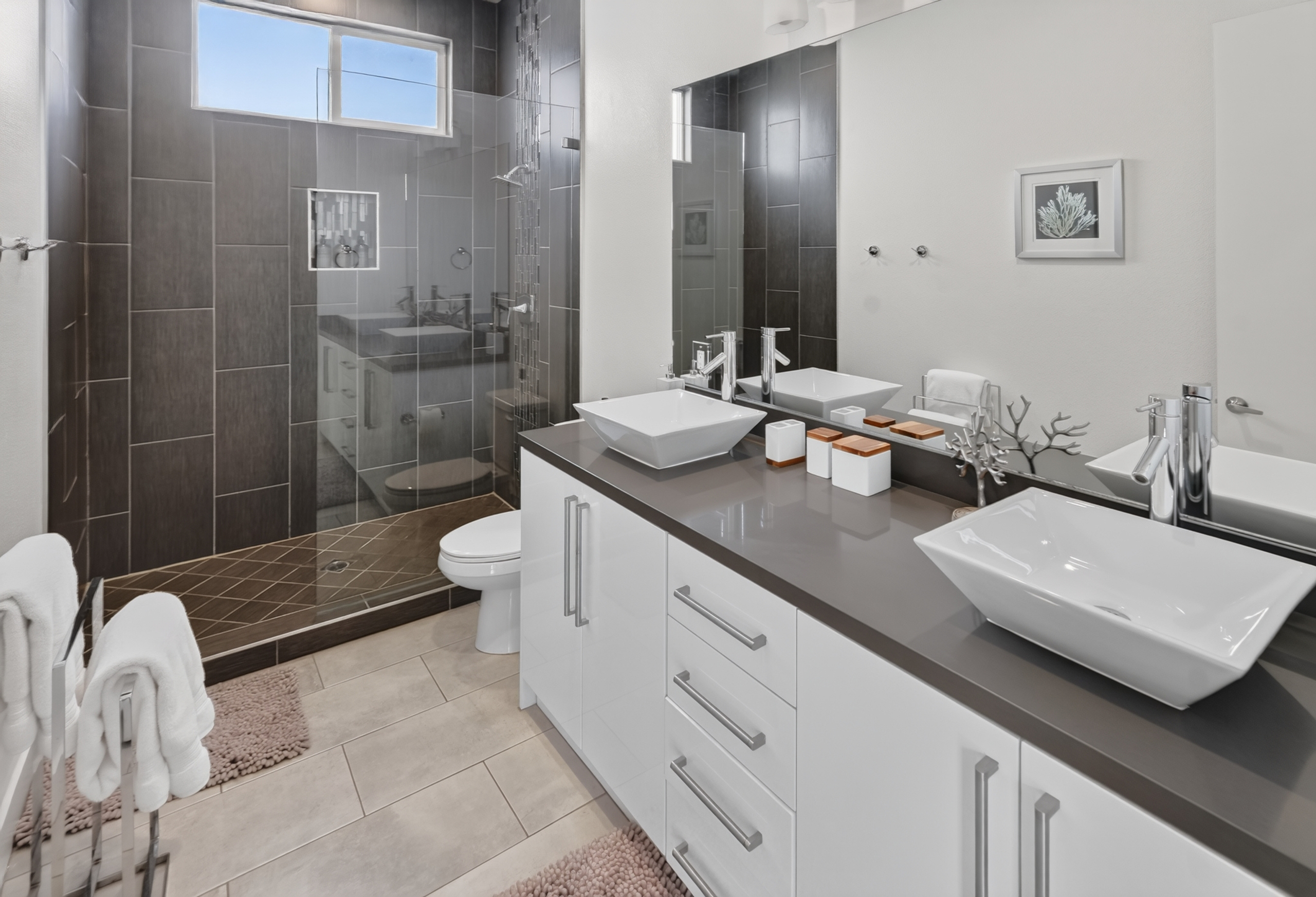 Modern spa-like bathroom with double vanity and glass walk-in shower
