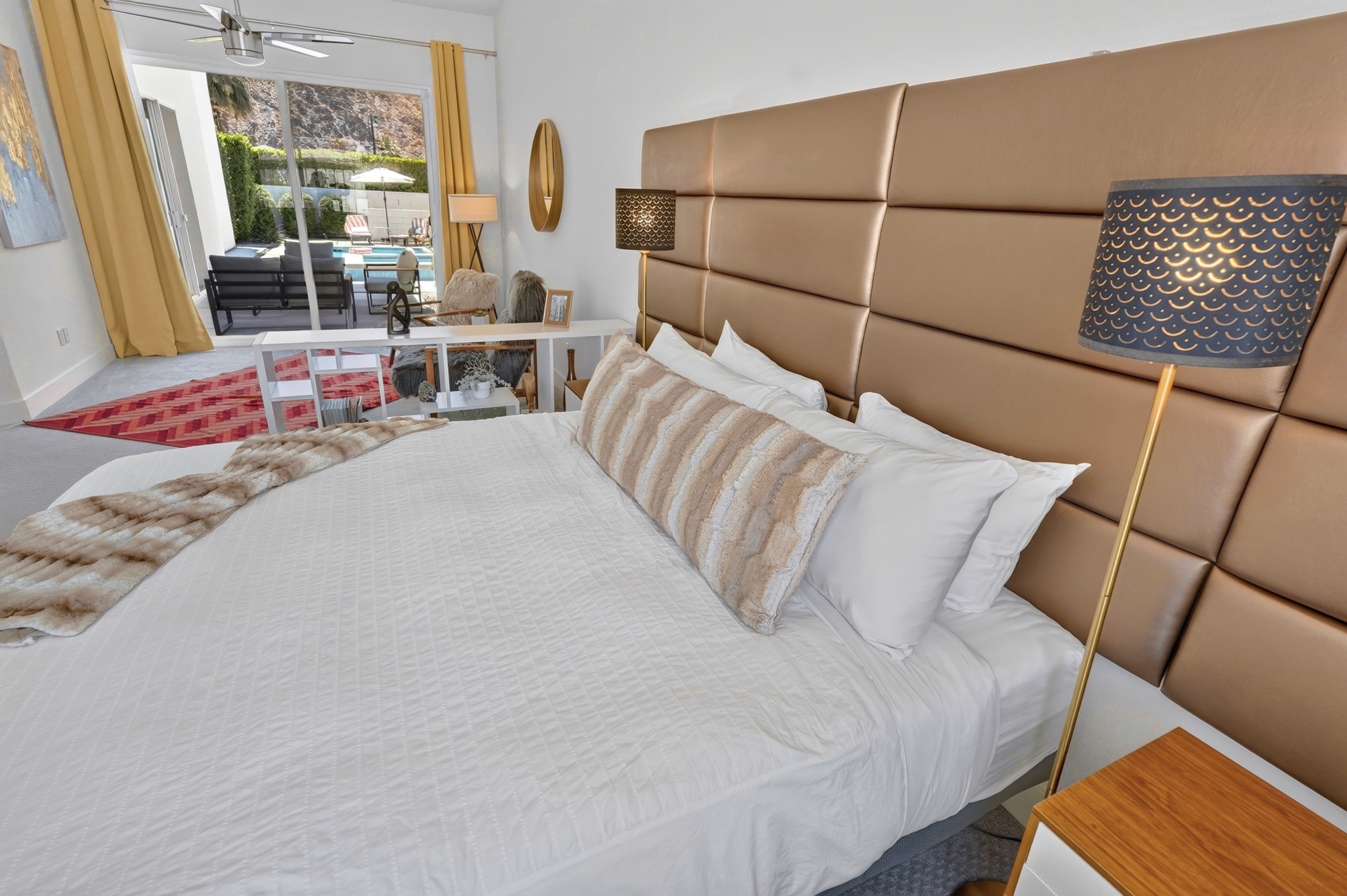 Bright king suite with patio access and inviting poolside views