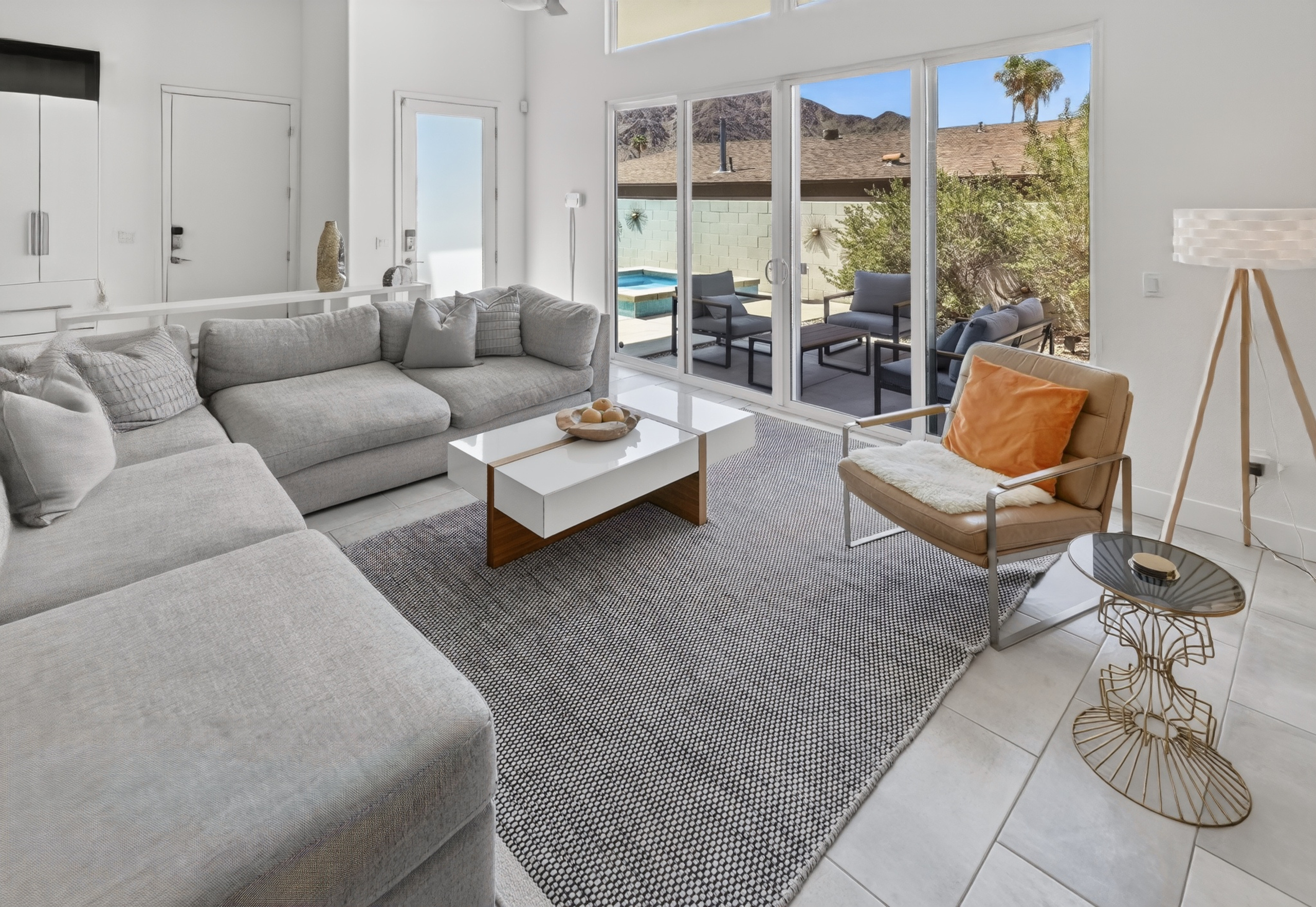 Bright modern lounge with patio seating and seamless indoor-outdoor flow