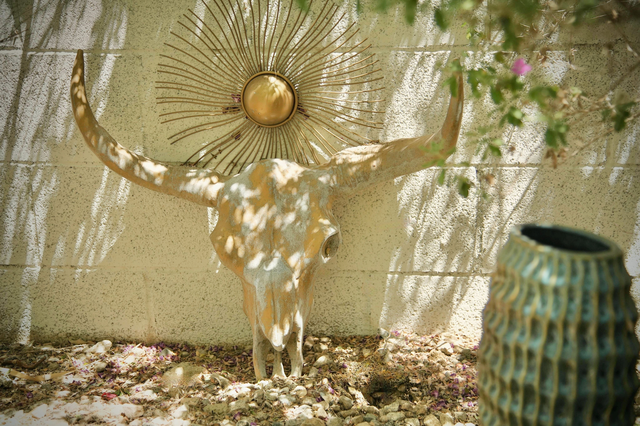 Southwestern courtyard detail with sunburst art and rustic desert charm