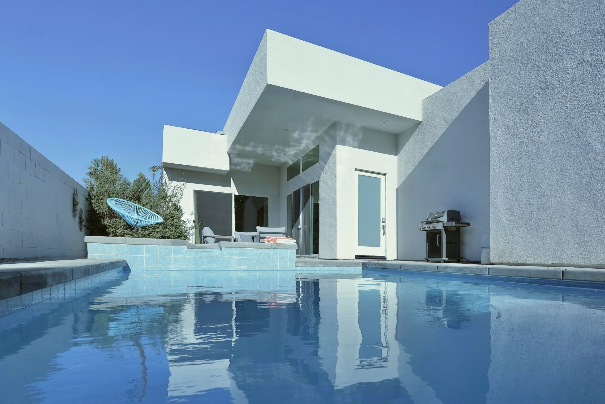 Modern private pool patio with grill and stylish resort-style vibes