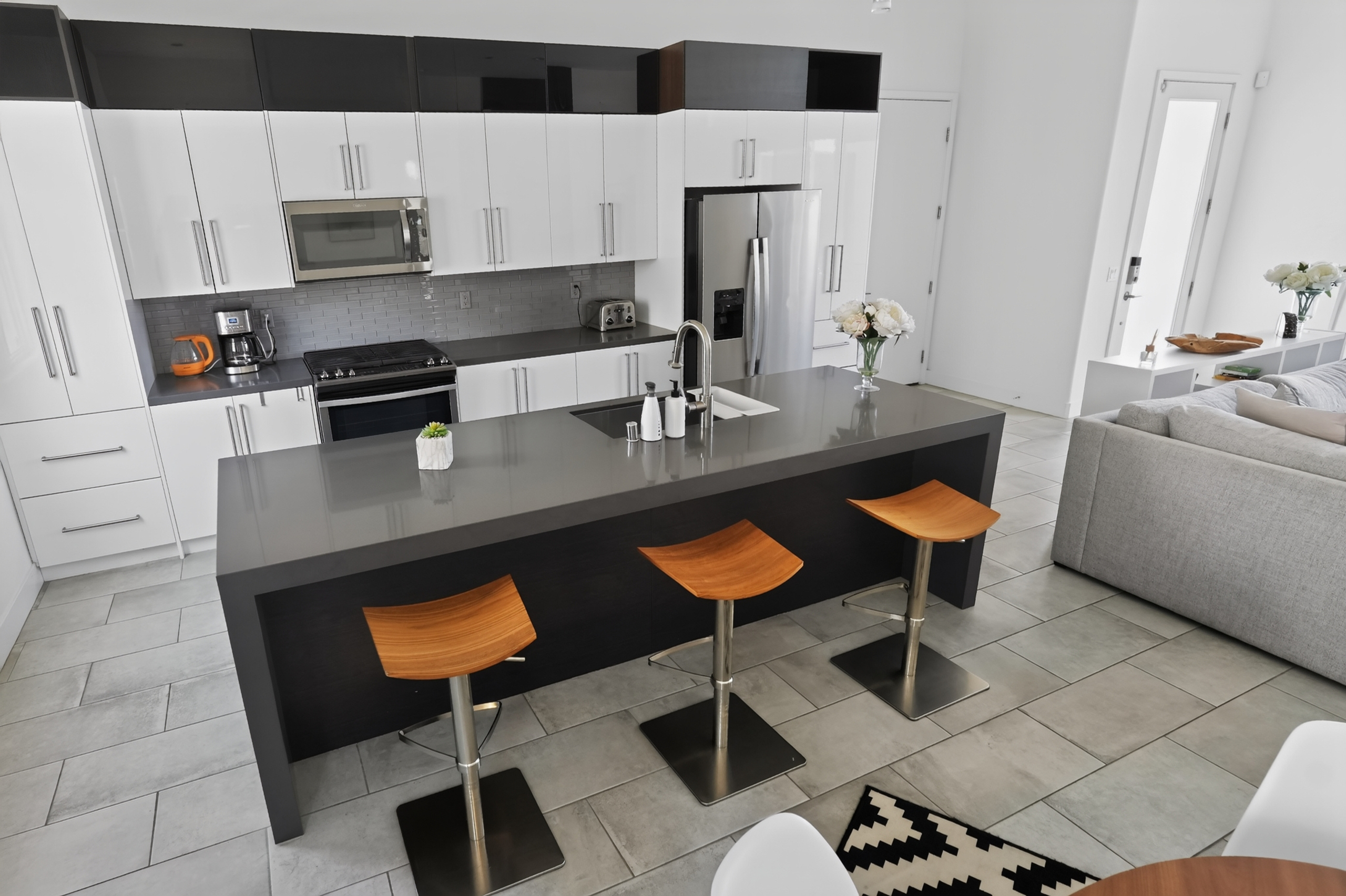 Sleek modern kitchen with waterfall island and seating for 3