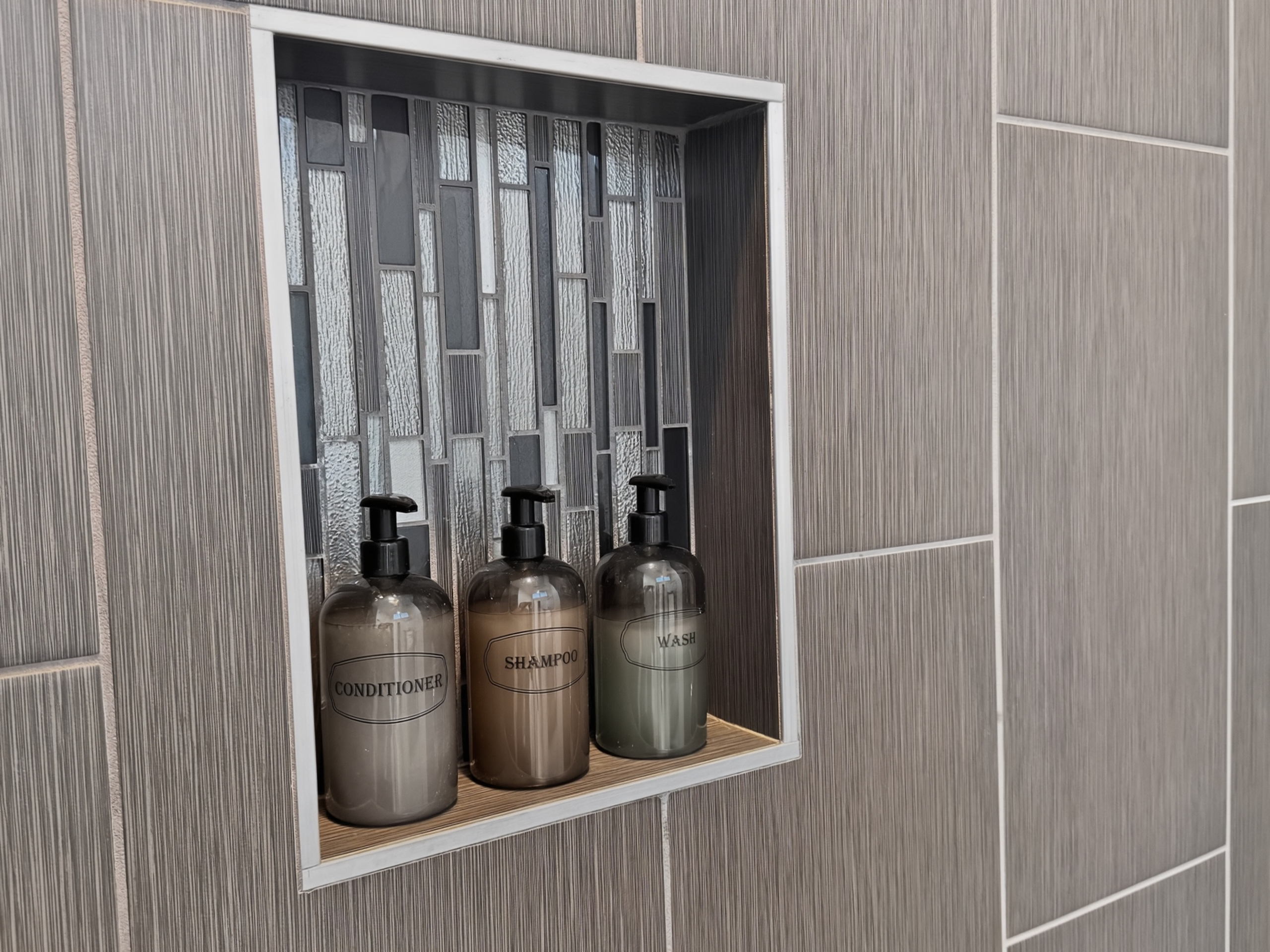 Modern tiled shower niche with premium bath essentials