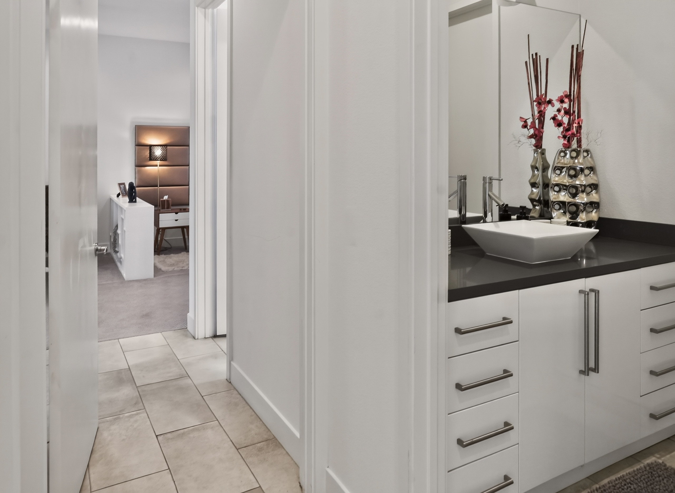 Modern hallway with sleek vanity and elegant bedroom access