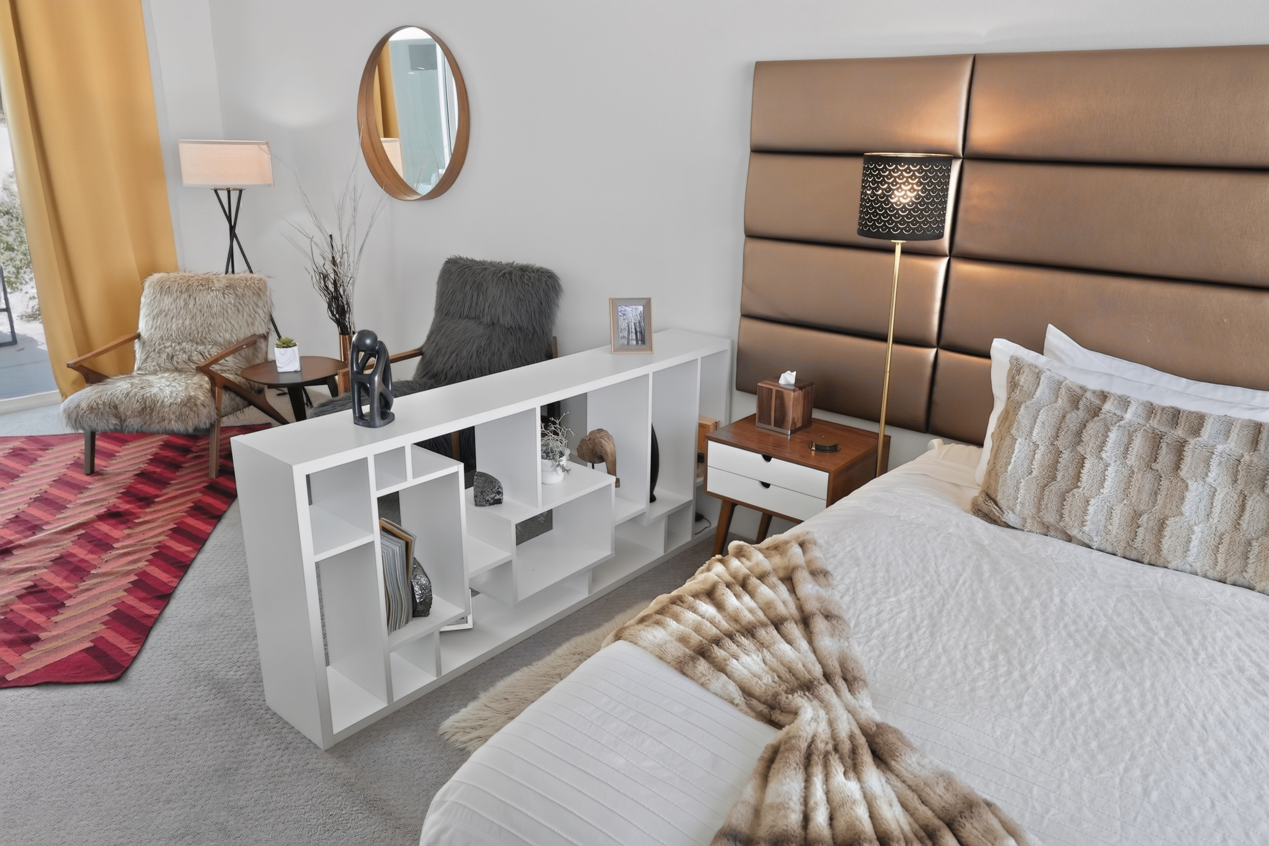 Cozy designer bedroom with sitting nook and chic modern touches