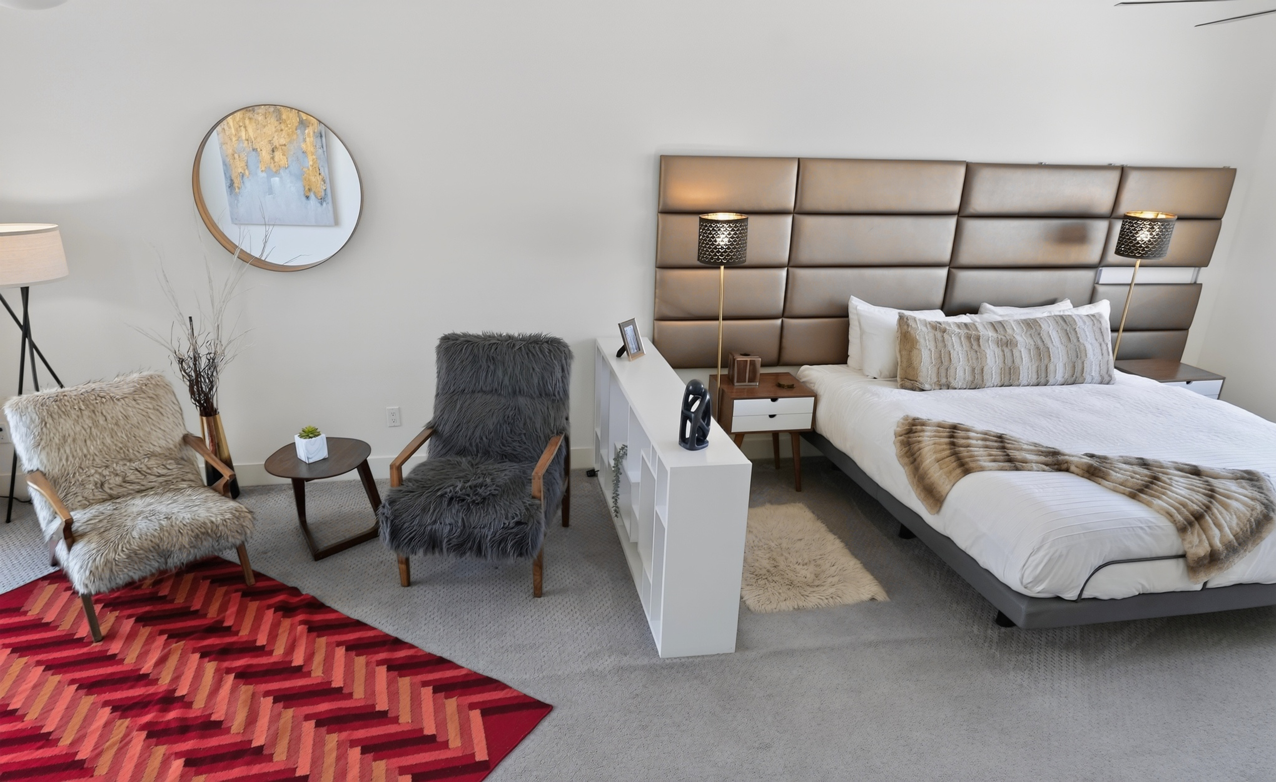 Cozy modern bedroom with luxe headboard and chic sitting area