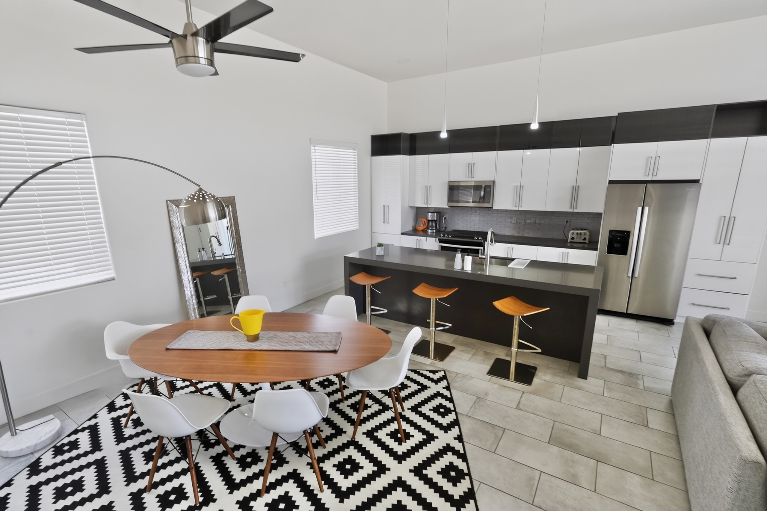 Bright modern kitchen and dining space with island seating and sleek finishes
