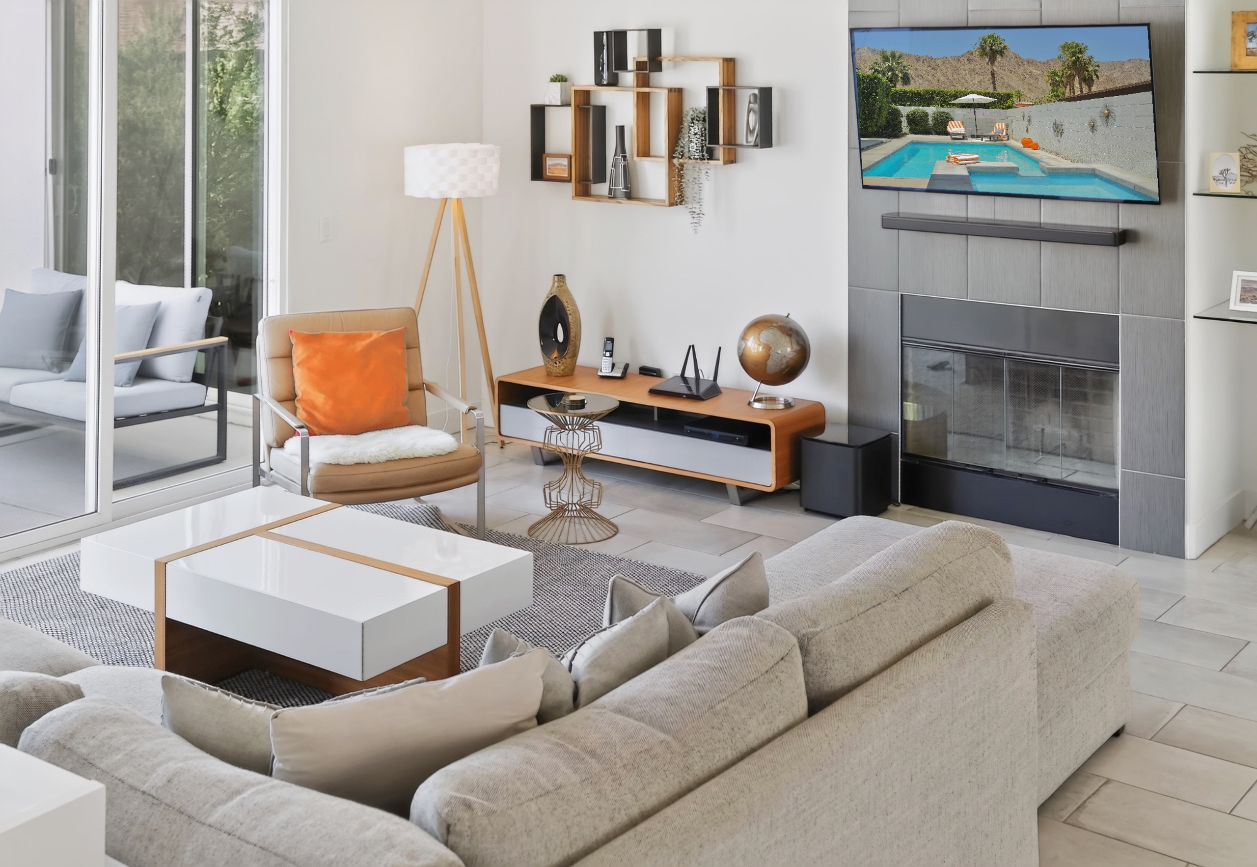 Bright modern living room with fireplace, TV, and indoor-outdoor flow