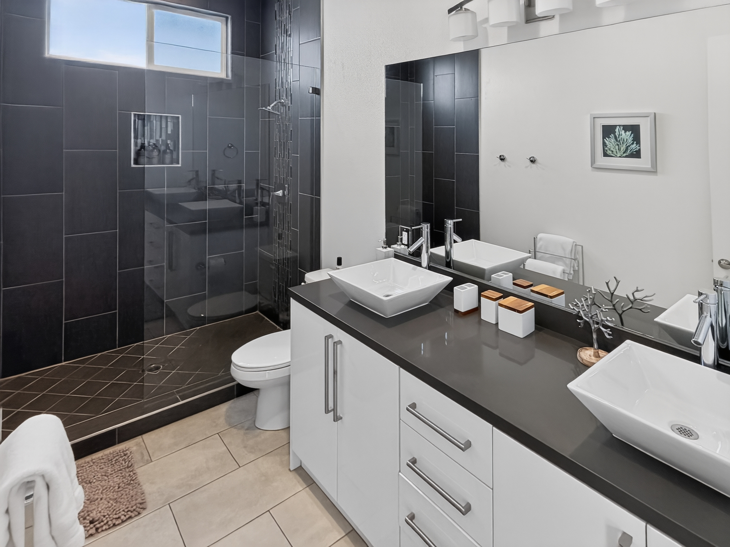 Modern spa-style bathroom with double vanity and walk-in glass shower