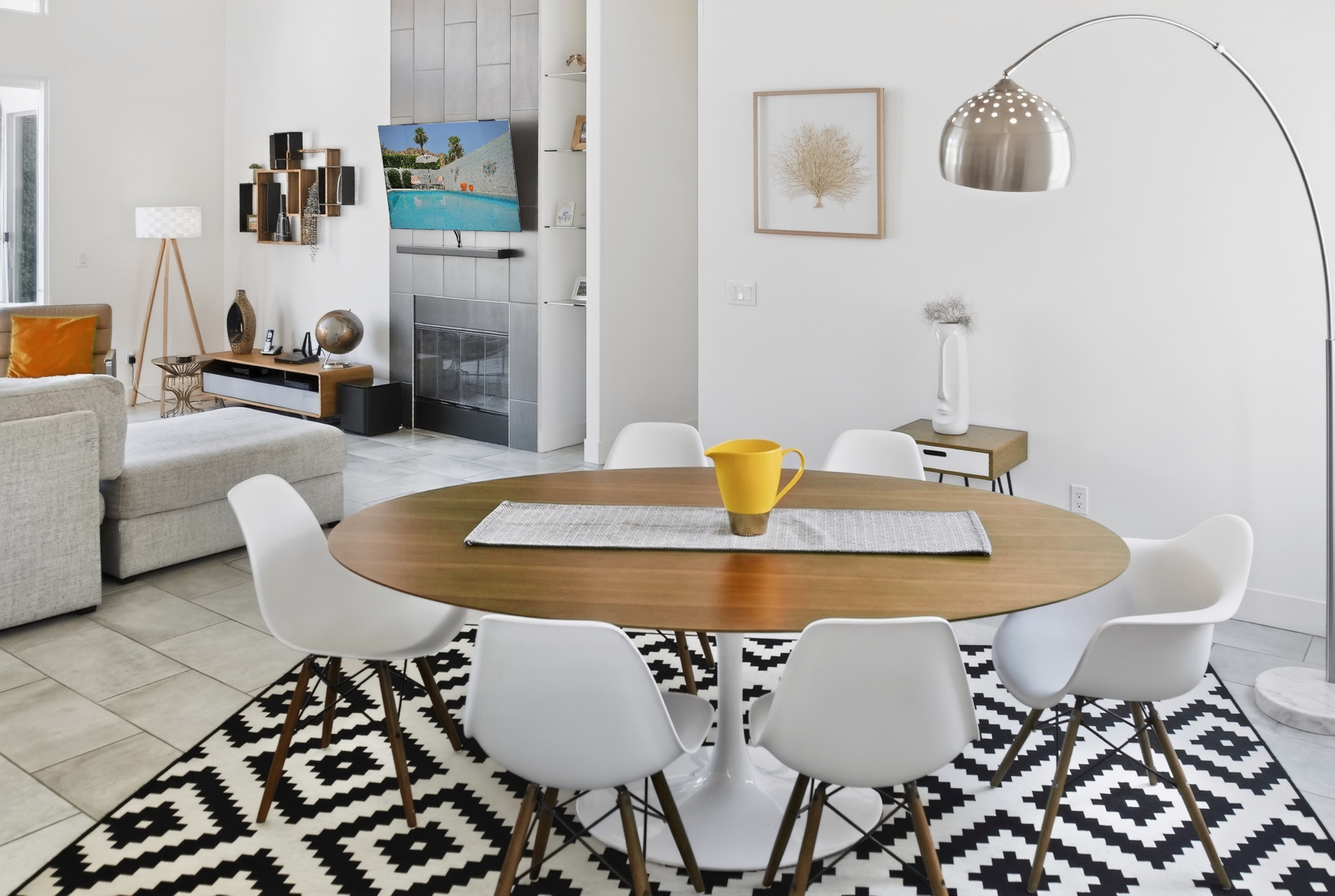 Bright modern dining area with seating for 6, fireplace, and open living space