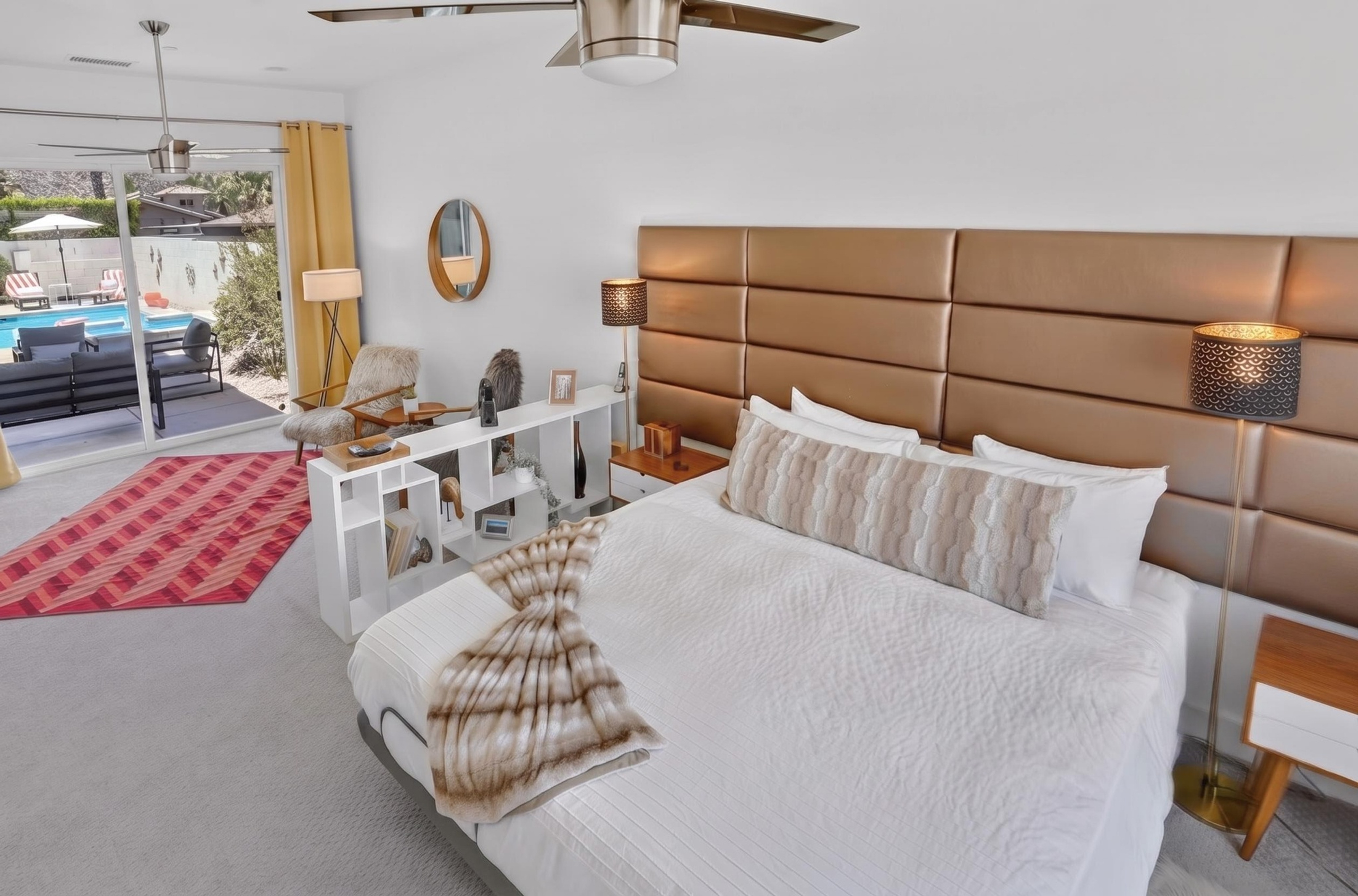 Bright pool-view bedroom with plush king bed and private patio access