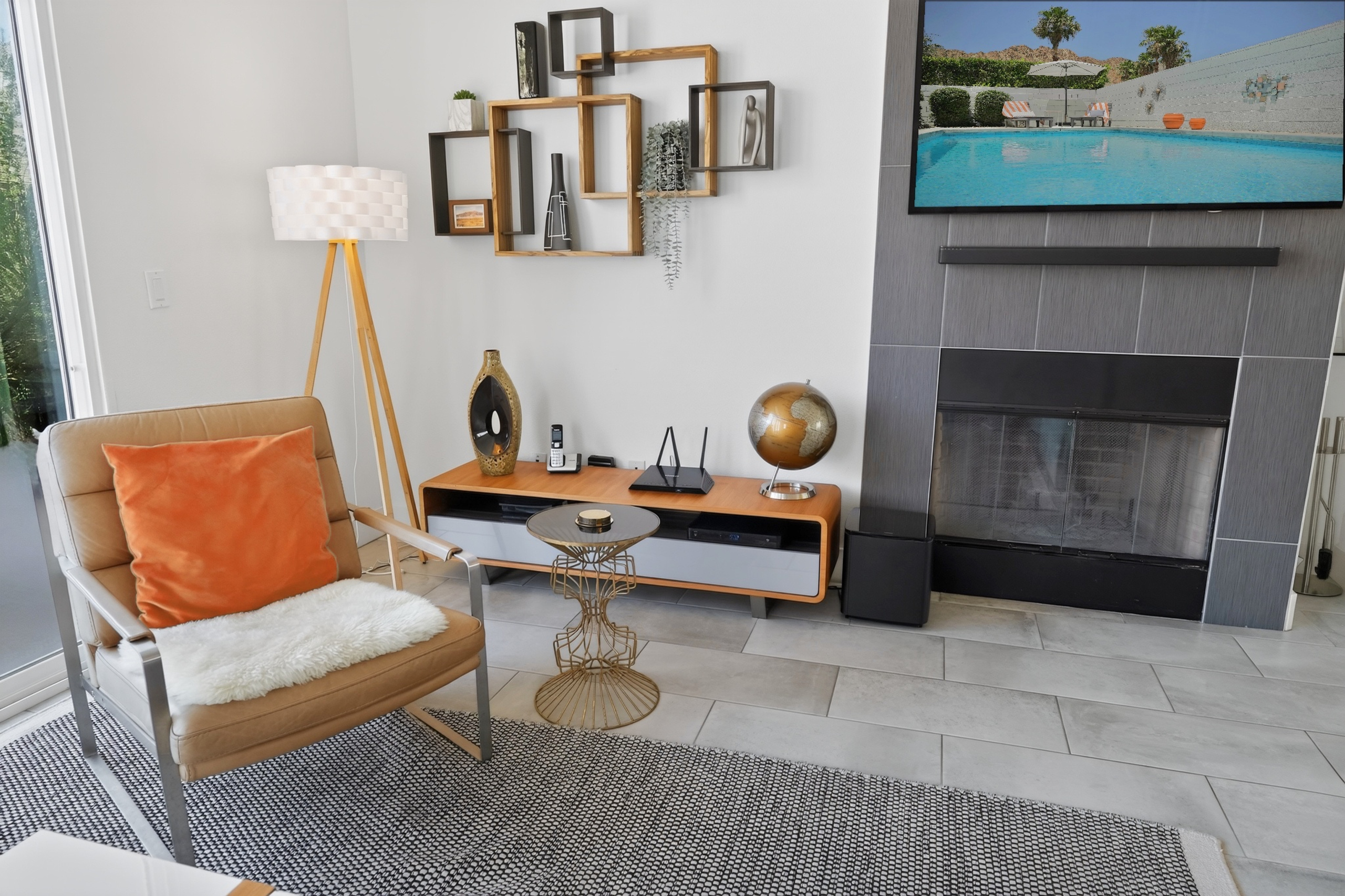 Modern lounge with fireplace, TV, and cozy designer touches