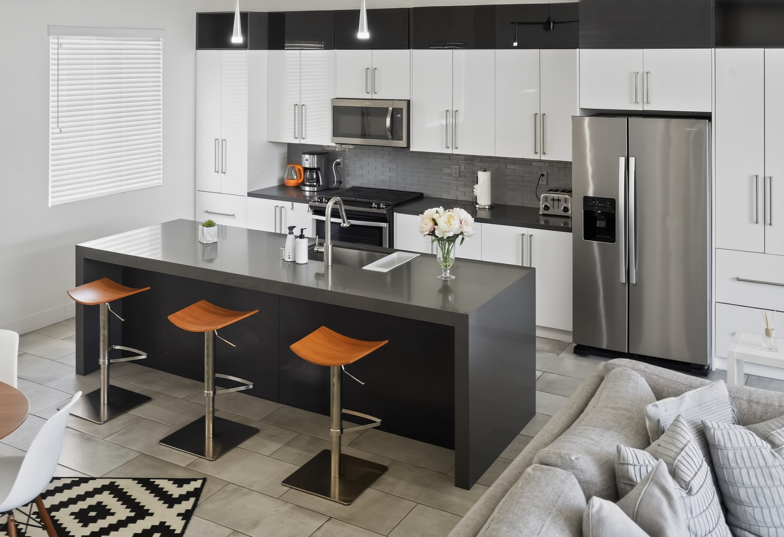 Bright modern kitchen with large island seating and stainless appliances
