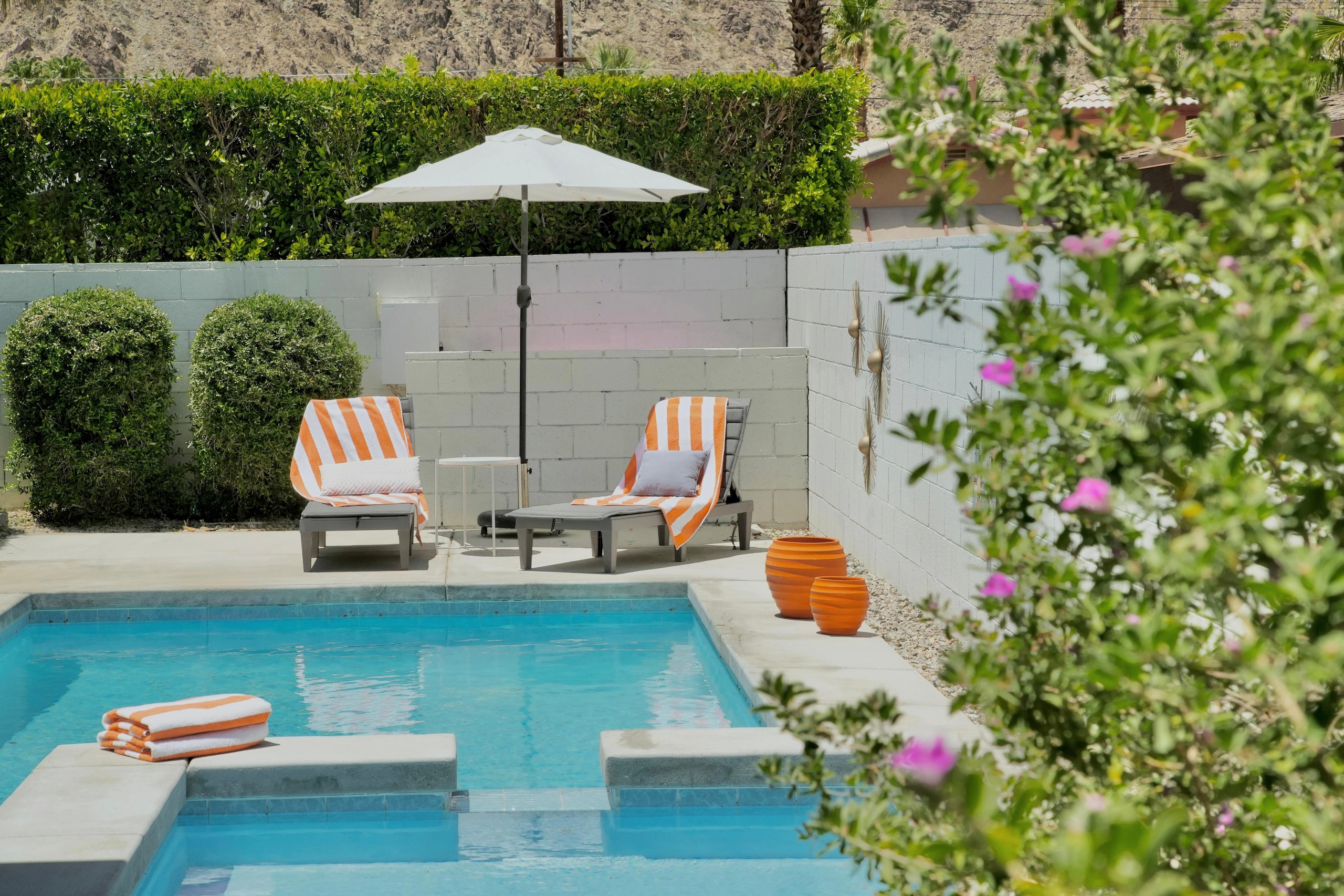 Private pool oasis with shaded loungers and sunny resort-style charm