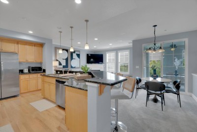 Fully Equipped Gourmet Kitchen! ️ Prepare any meal in this  modern kitchen with stainless steel appliances and a large granite island for prep. Wood cabinetry, a full dining nook for four, and bar seating make it perfect for gathering. 